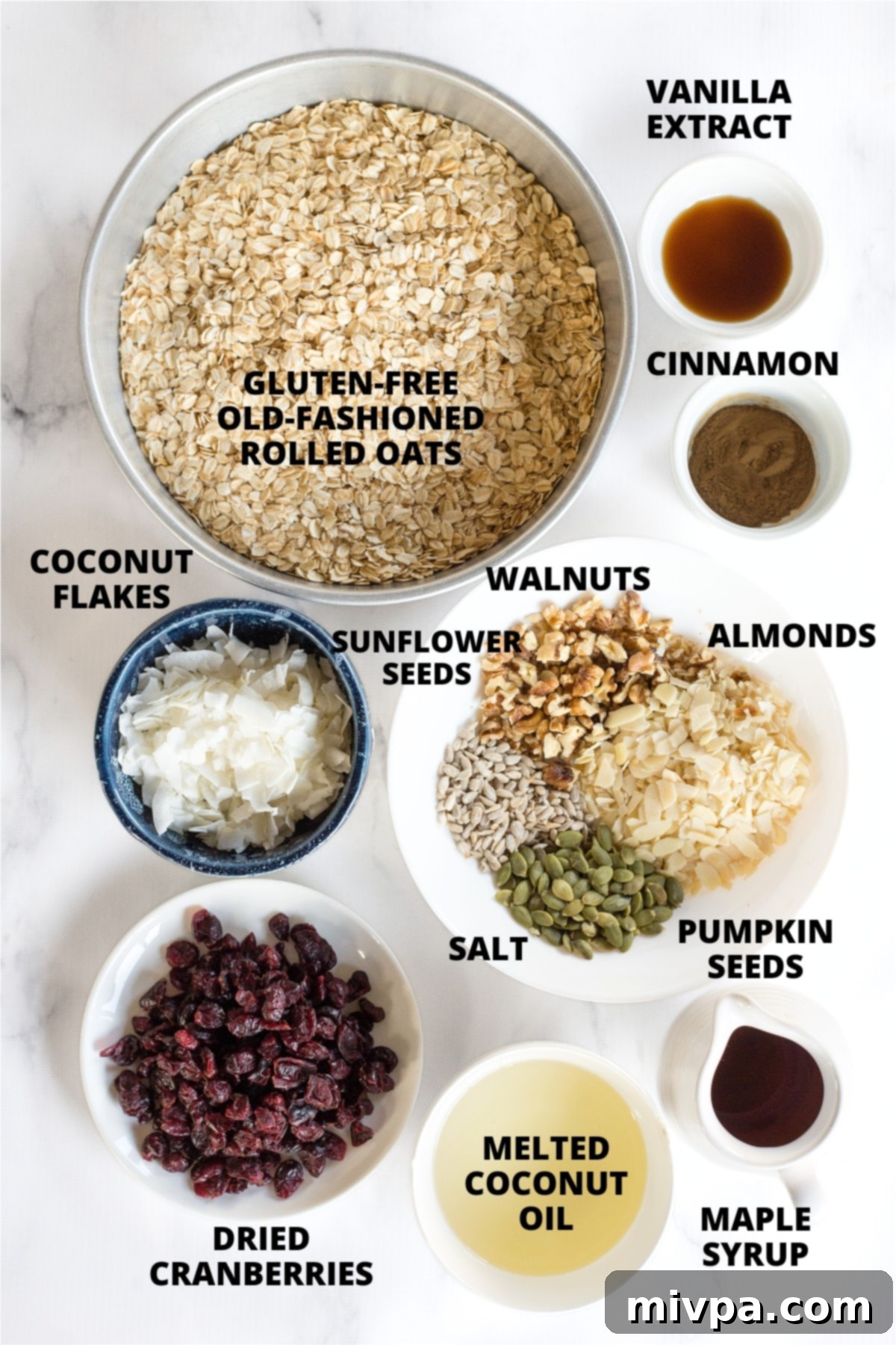Homemade Gluten-Free Granola Recipe (Vegan) Ingredients for homemade gluten-free granola recipe laid out on marble board.