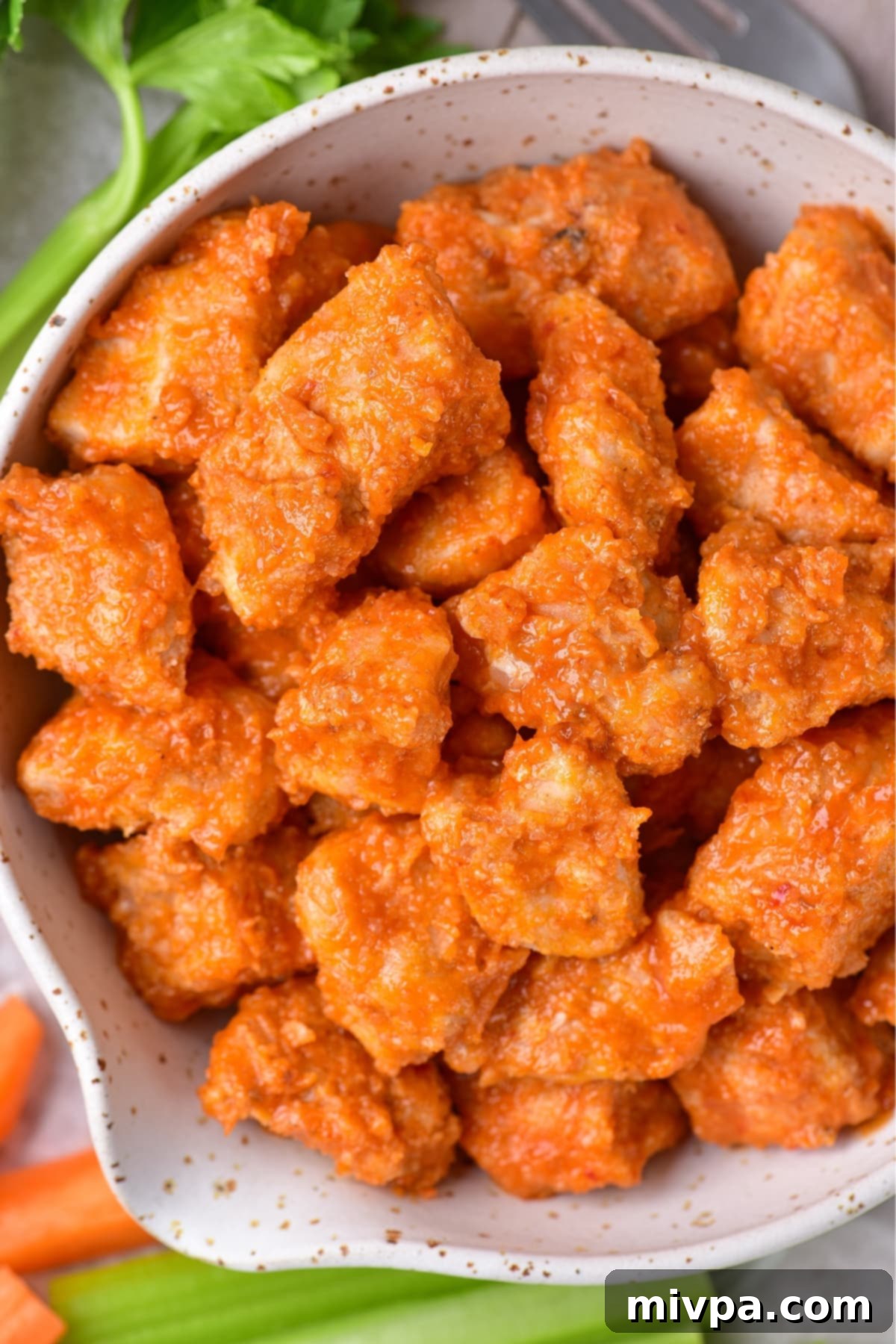 Up close shot of a bowl of buffalo chicken bites.