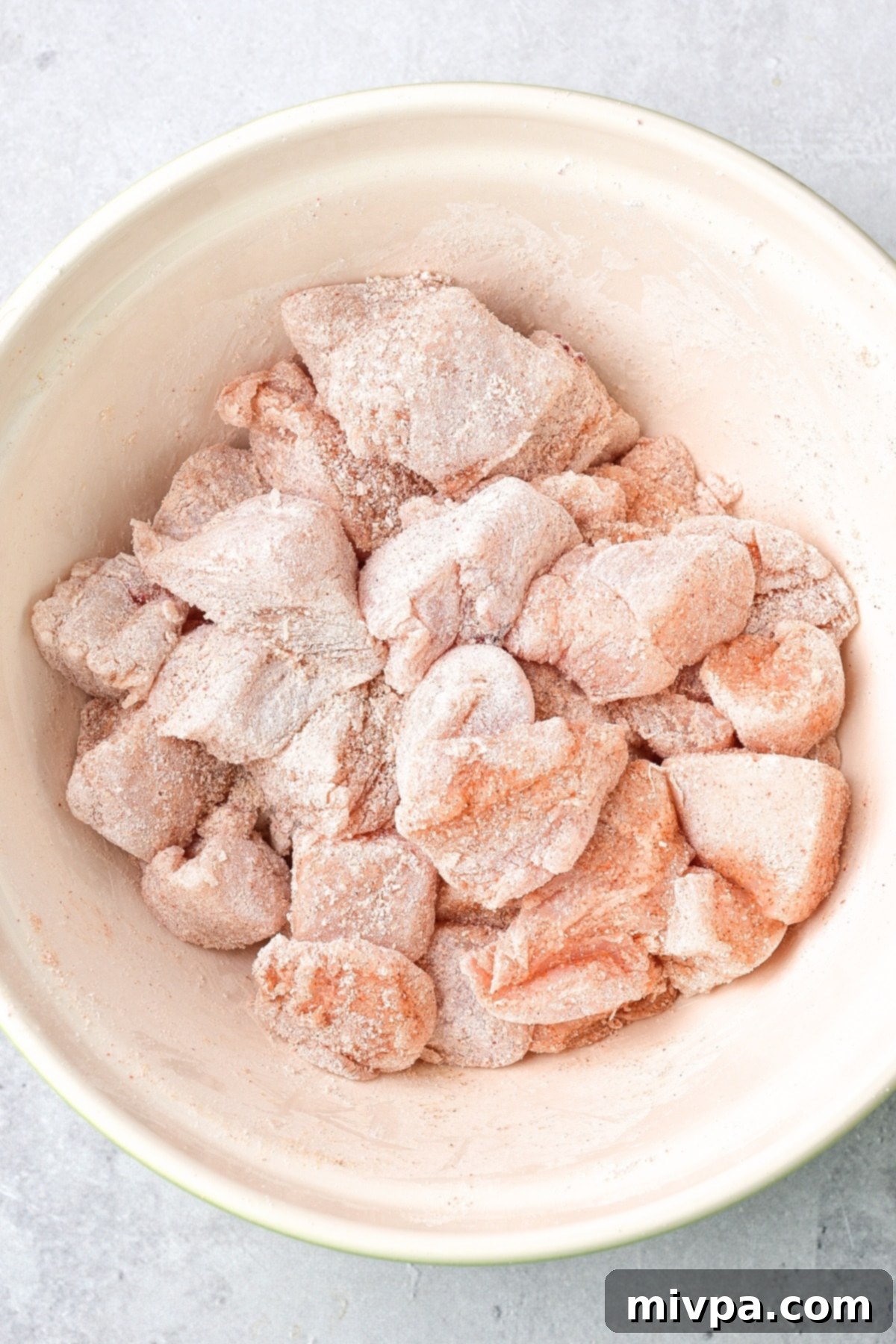 Coated chicken bites in bowl.