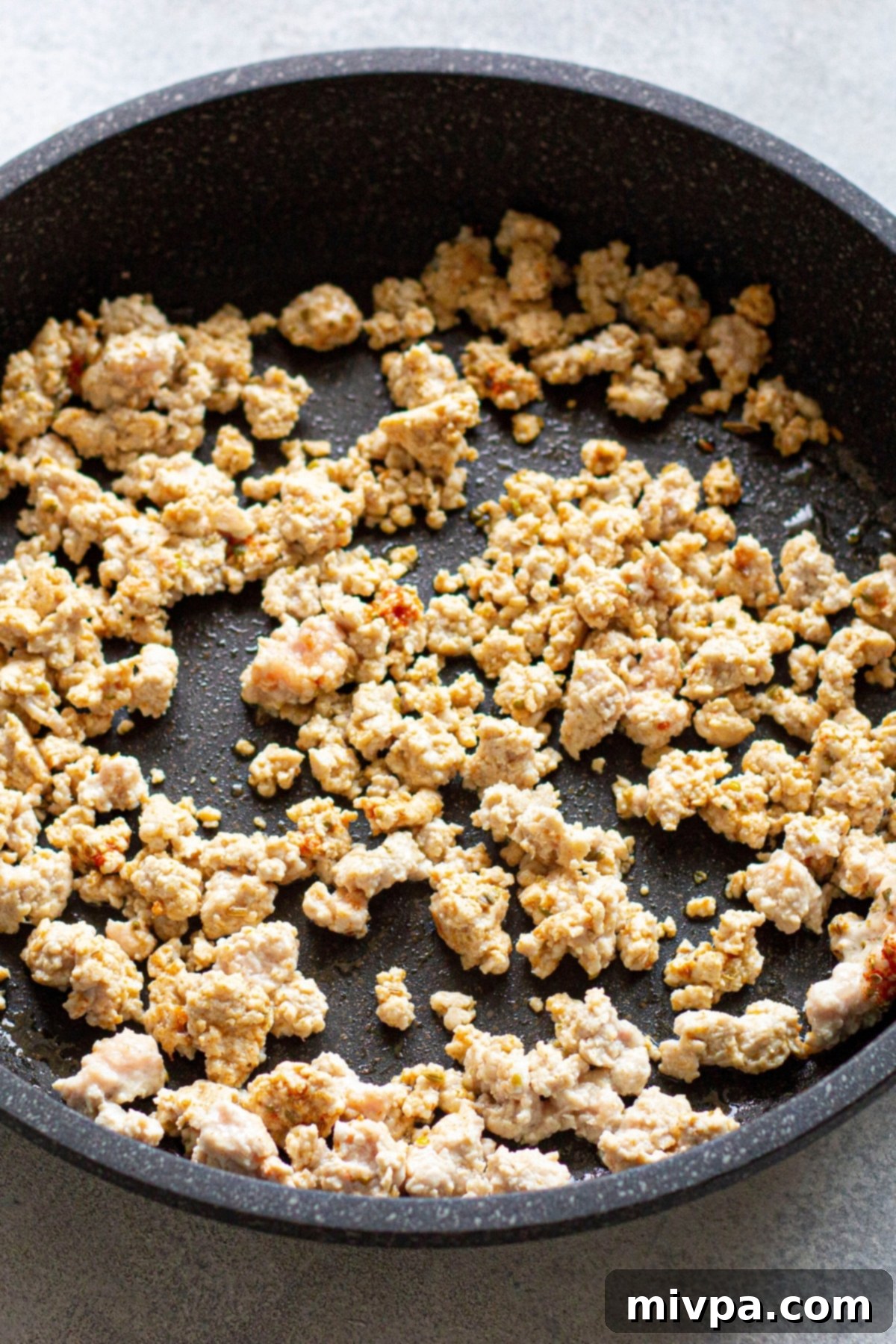 Hearty Chickpea Kale Soup (Gluten-Free, Dairy-Free) Cooking ground chicken in skillet.