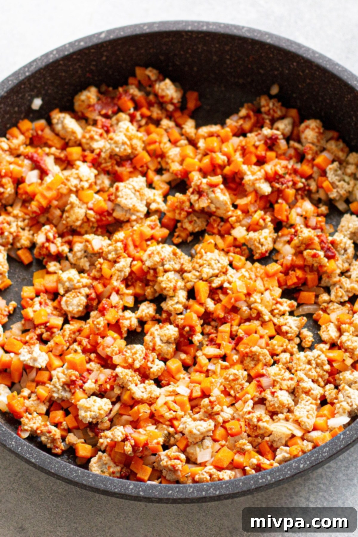 Chickpea Chicken Soup Recipe Cooking chicken, carrots and onions in skillet.