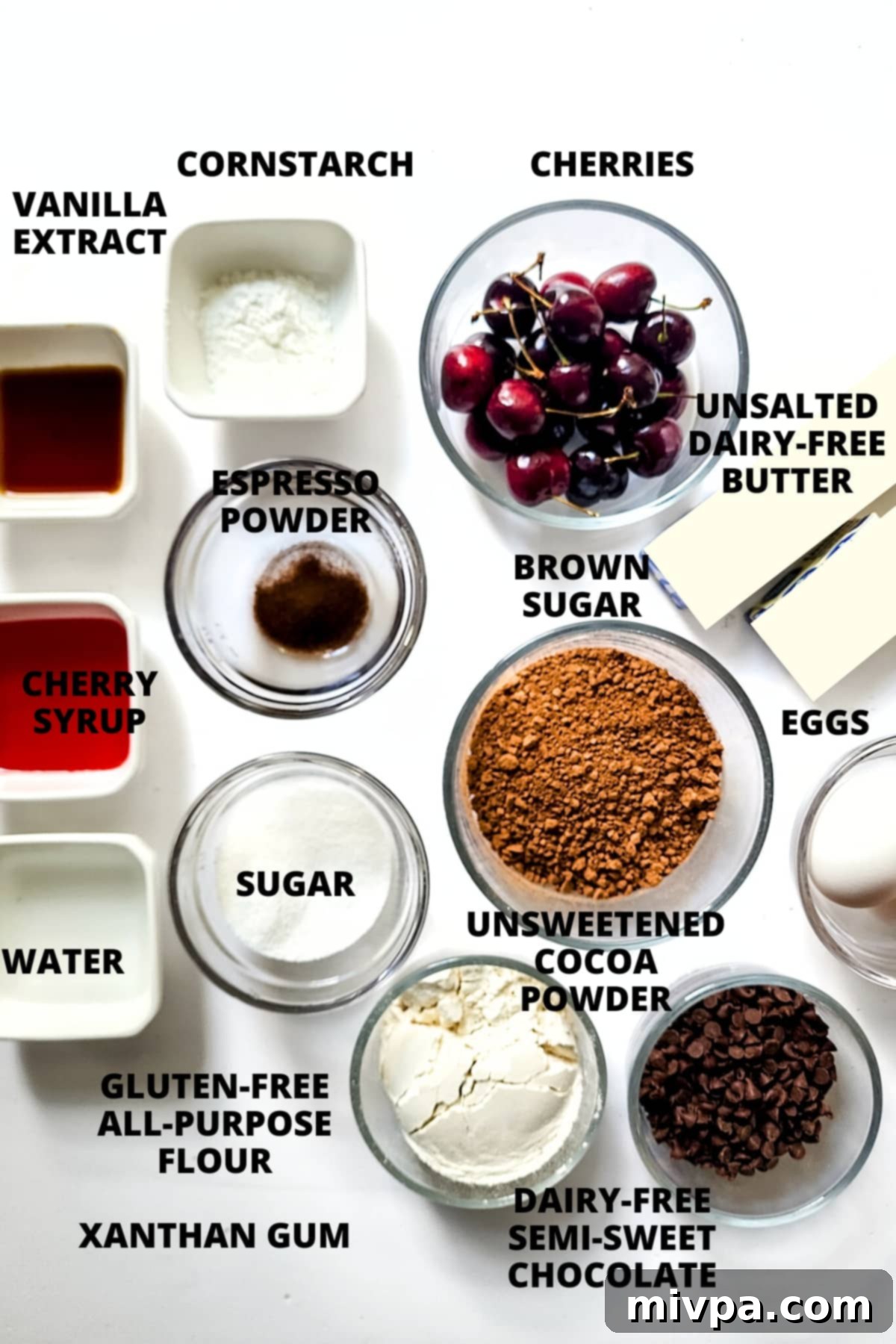 Easy Black Forest Brownies Recipe (Gluten-Free, Dairy-Free) A vibrant flat lay of all the essential ingredients for Black Forest Brownies, neatly arranged on a white background, including fresh cherries, chocolate, sugars, and flours.