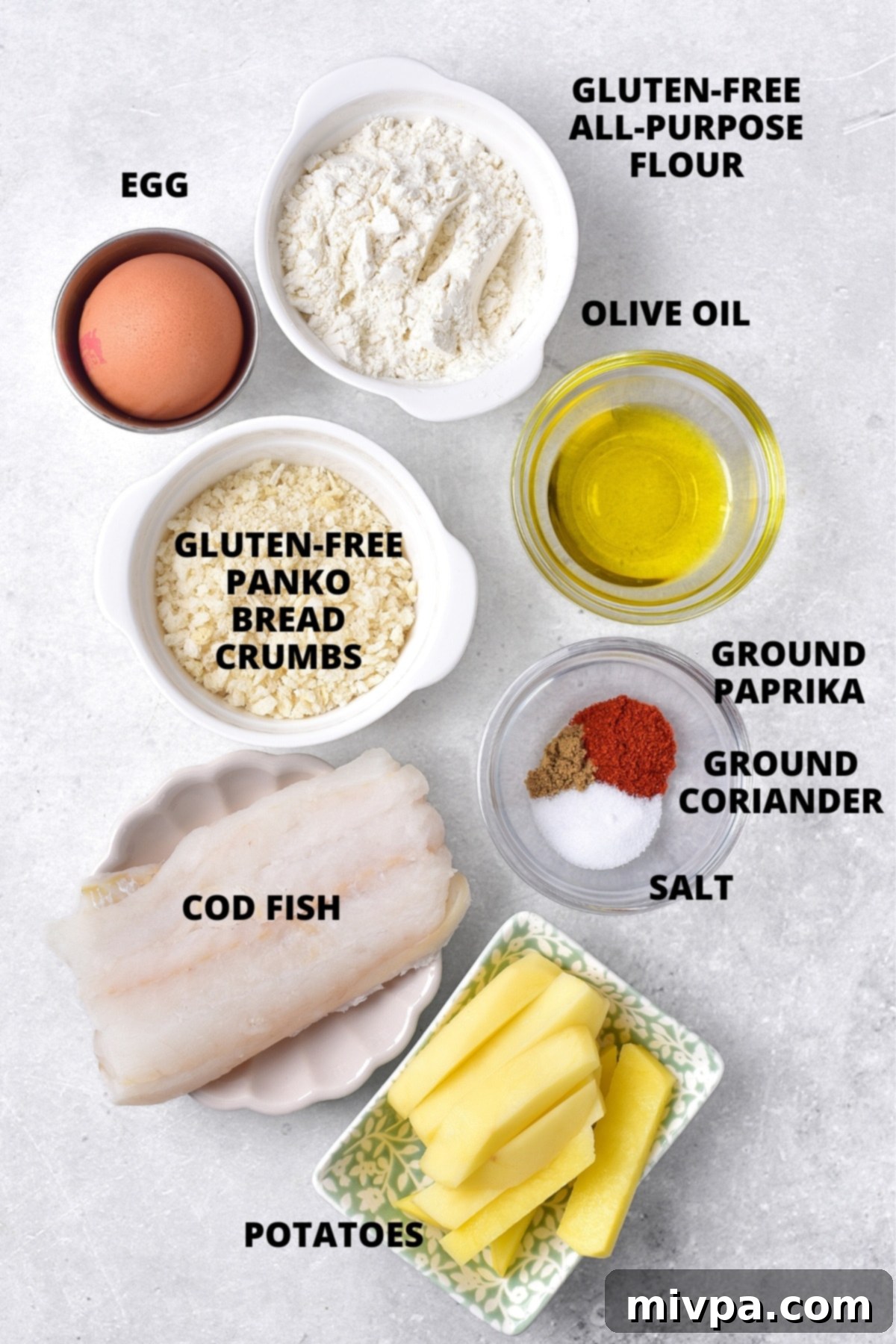 Ingredients for gluten-free fish and chips, neatly laid out on a wooden cutting board.