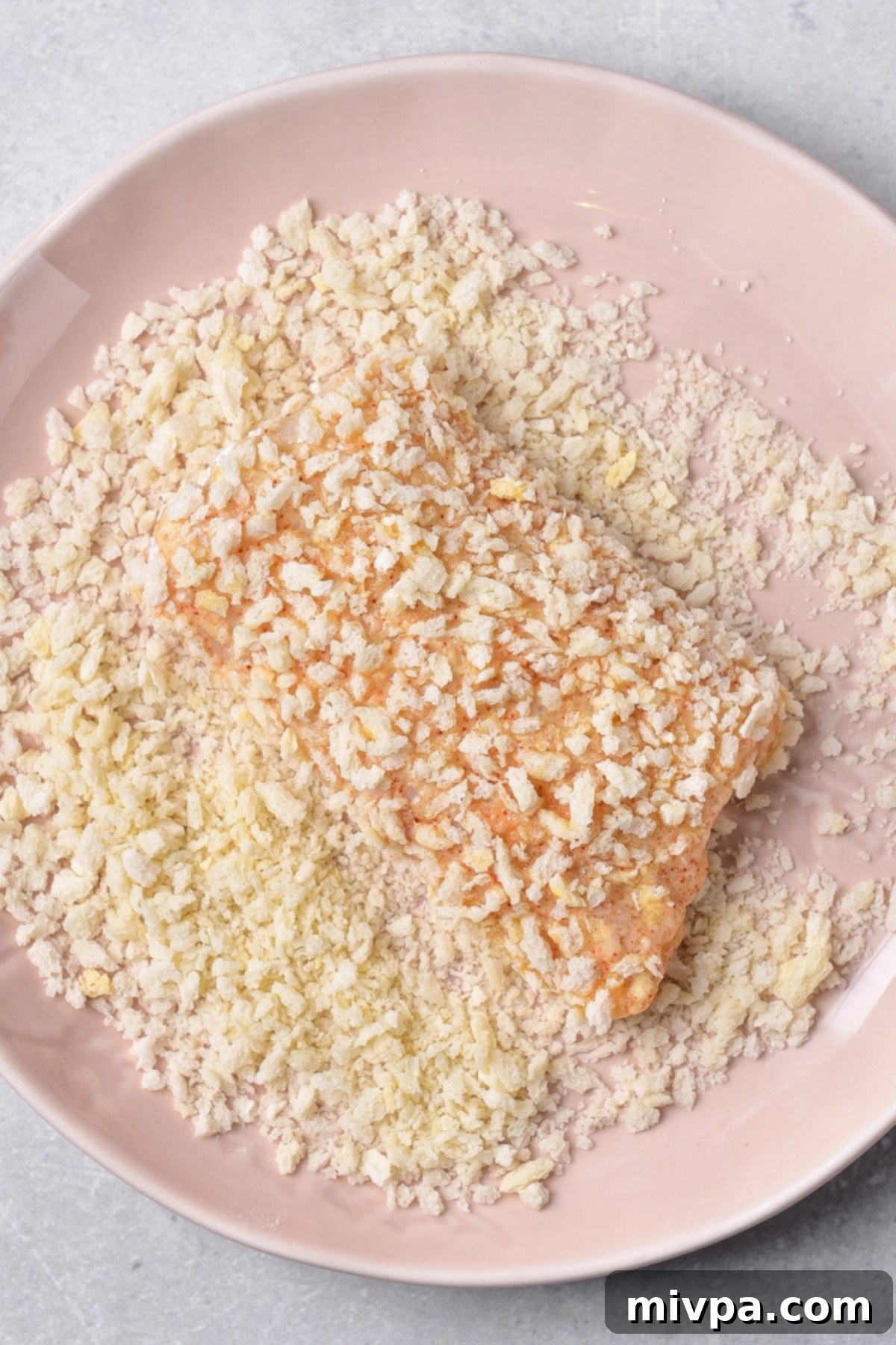 How to Make Gluten-Free Fish and Chips Coating cod fish in panko bread crumbs mixture.