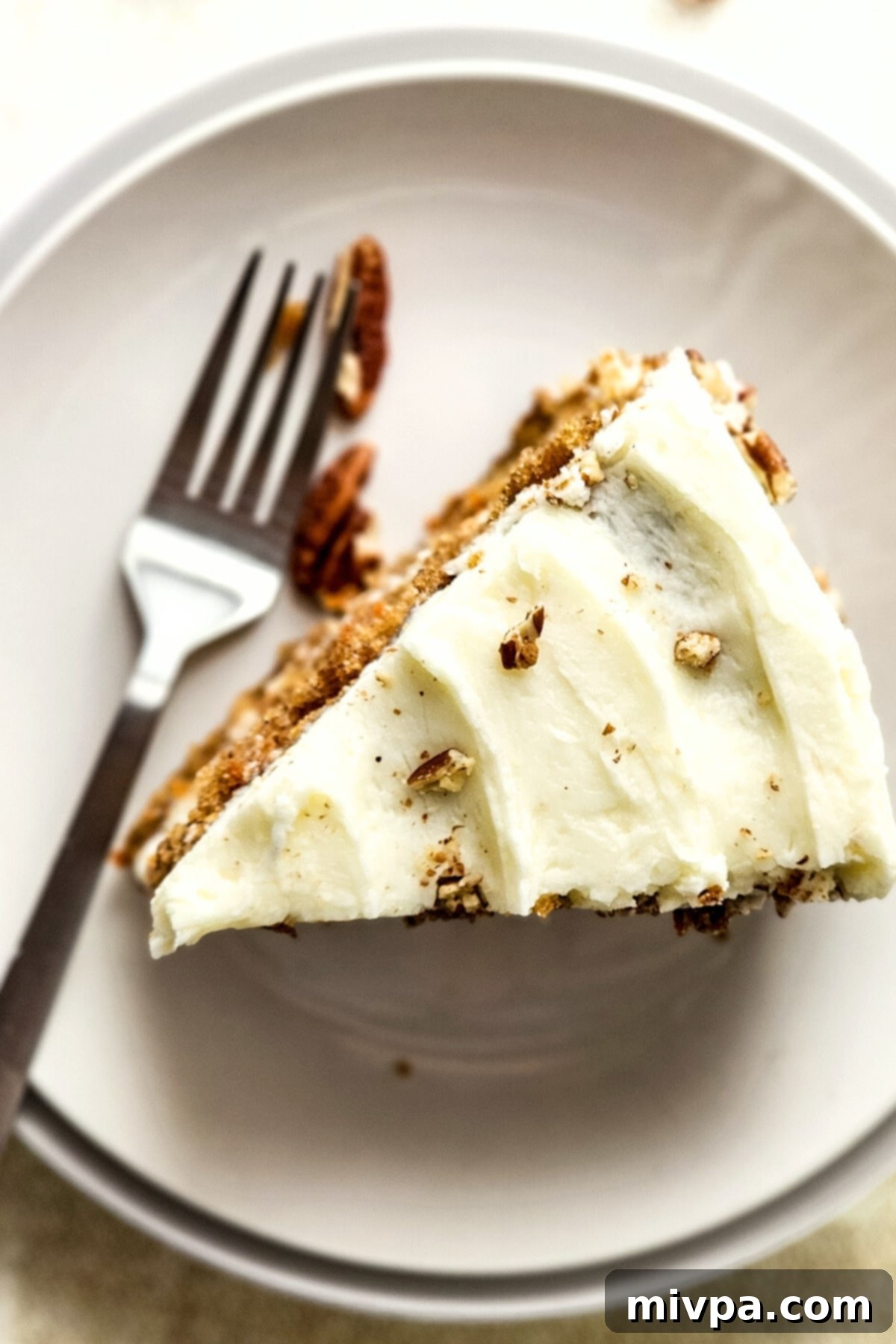 GF Carrot Cake with Frosting Top down view of a slice of carrot cake with cream cheese frosting.
