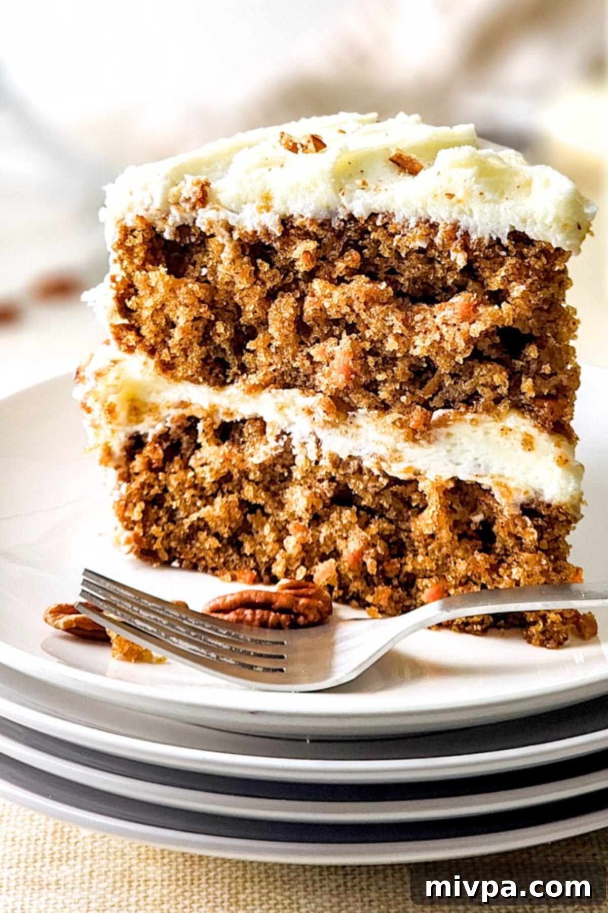 Easy Carrot Cake (Gluten-Free, Dairy-Free) A big slice of gf carrot cake on white plate.