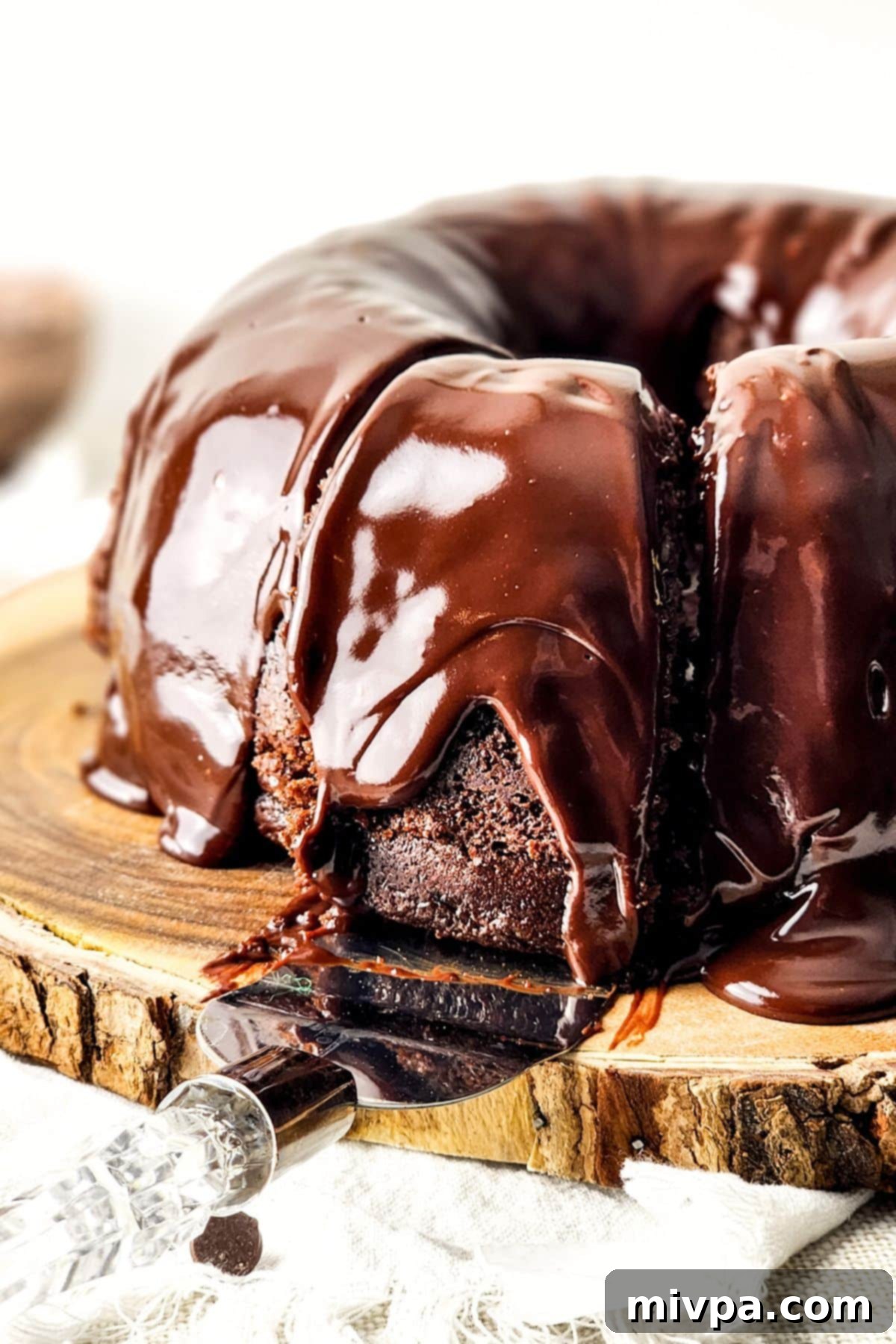 Gluten-Free Chocolate Bundt Cake (Dairy-Free) Reaching for a slice of gluten-free chocolate bundt cake.