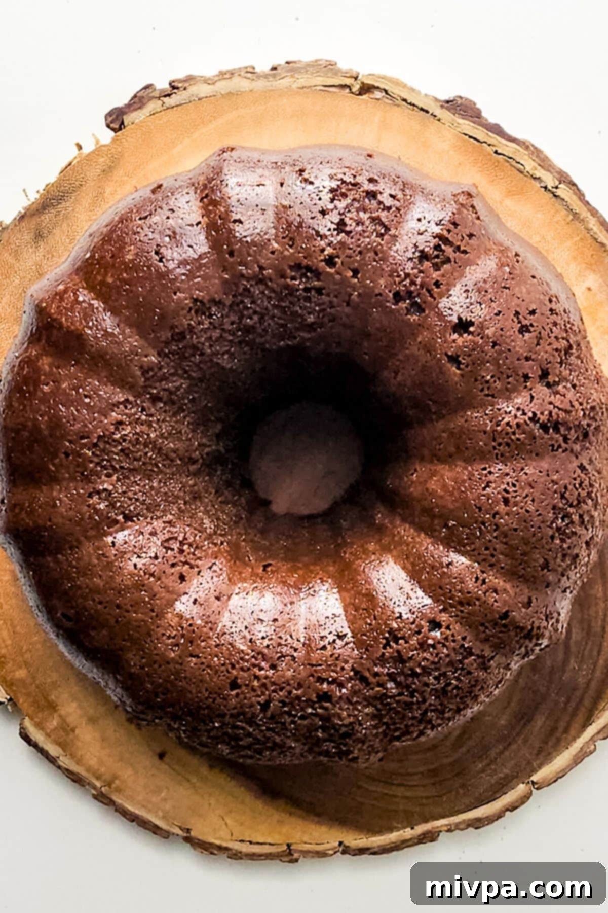 Moist Chocolate Cake Recipe (Gluten-Free) Chocolate bundt cake on wooden board.