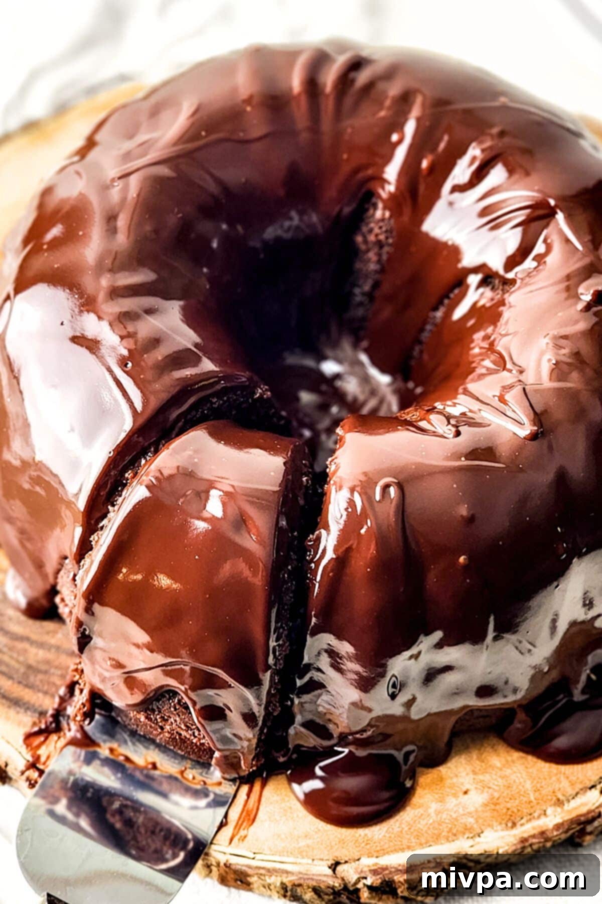 GF Chocolate Bundt Cake Reaching for a slice of gluten-free chocolate bundt.