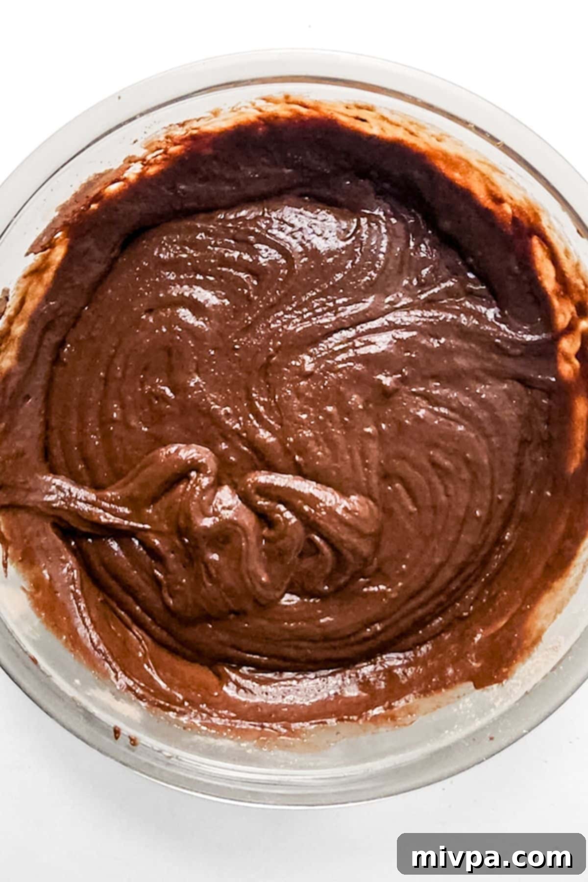 Gluten-Free Dairy-Free Chocolate Bundt Cake Mixing chocolate cake batter in bowl.