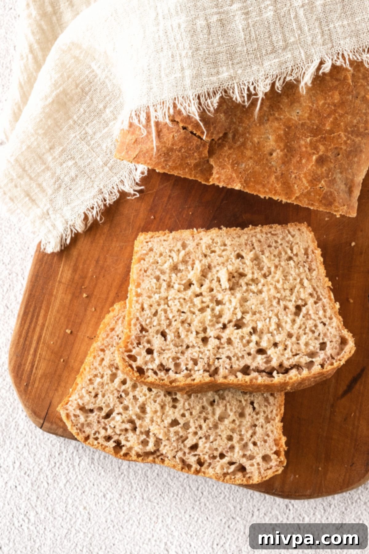 Easy Beer Bread with Yeast Close-up view of multiple slices of easy beer bread with yeast on a wooden board, ready to be enjoyed.