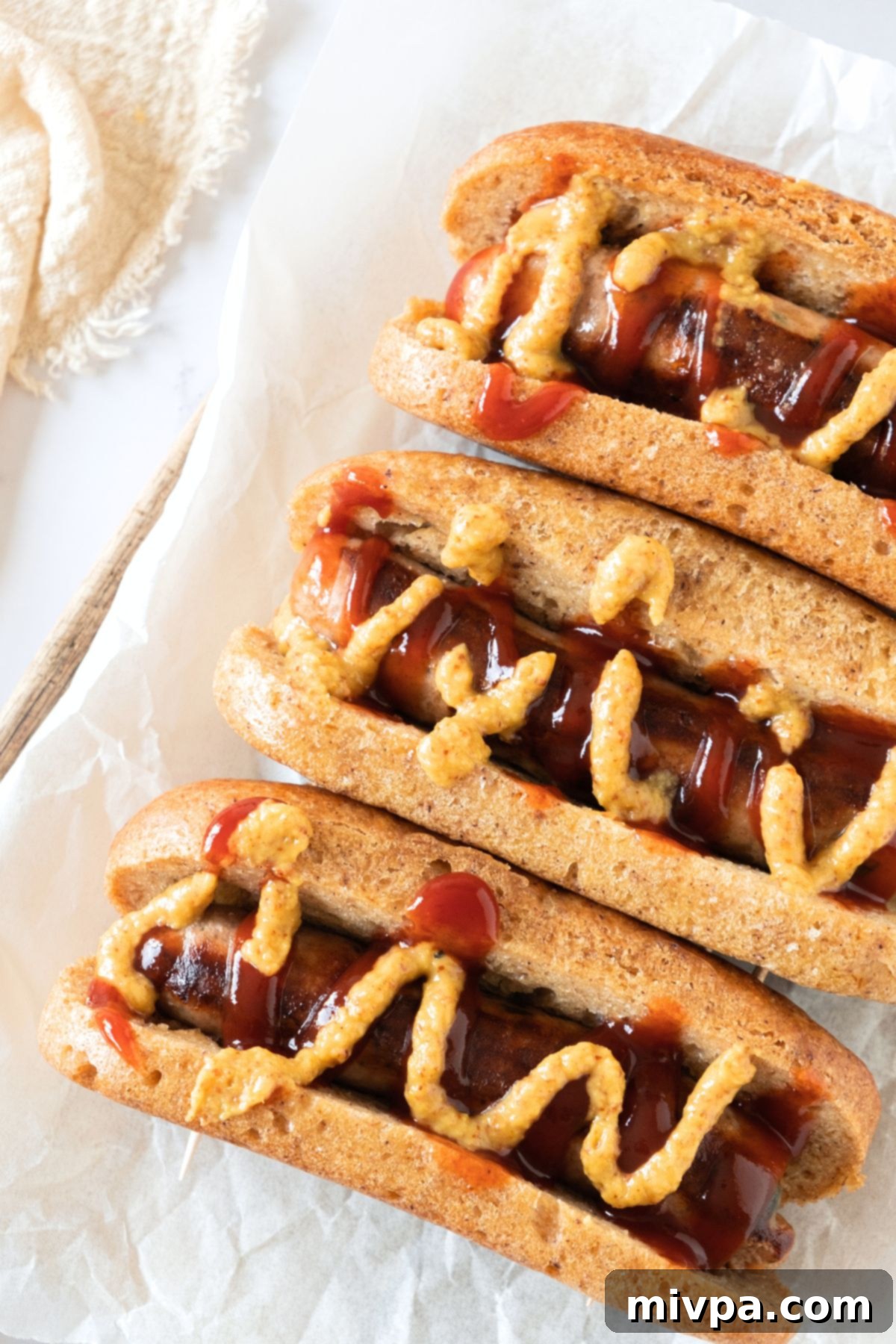 Gluten-Free Hot Dogs Hot dogs topped with mustard and ketchup.