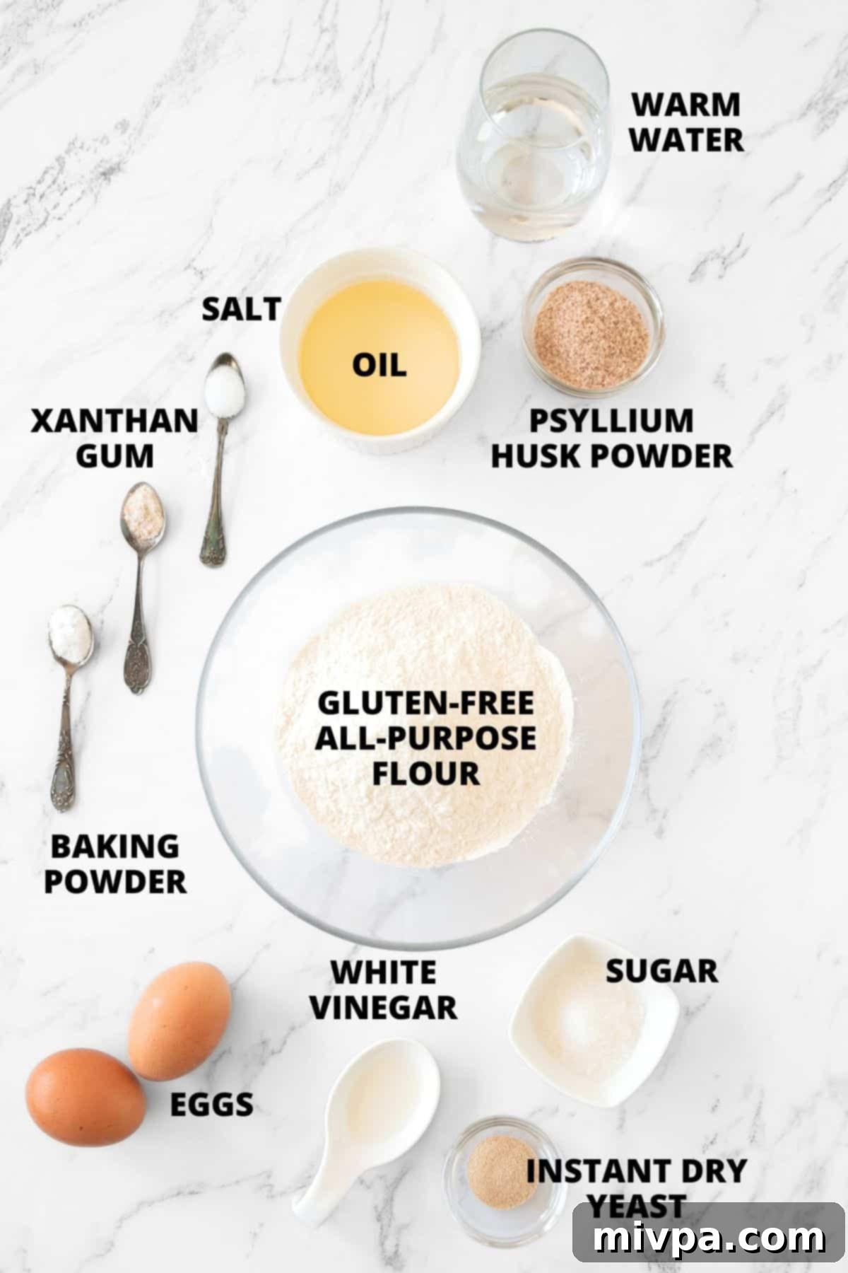 Gluten-Free Hot Dog Buns Recipe (Dairy-Free) Ingredients for gluten-free hot dog buns recipe laid out on marble board.