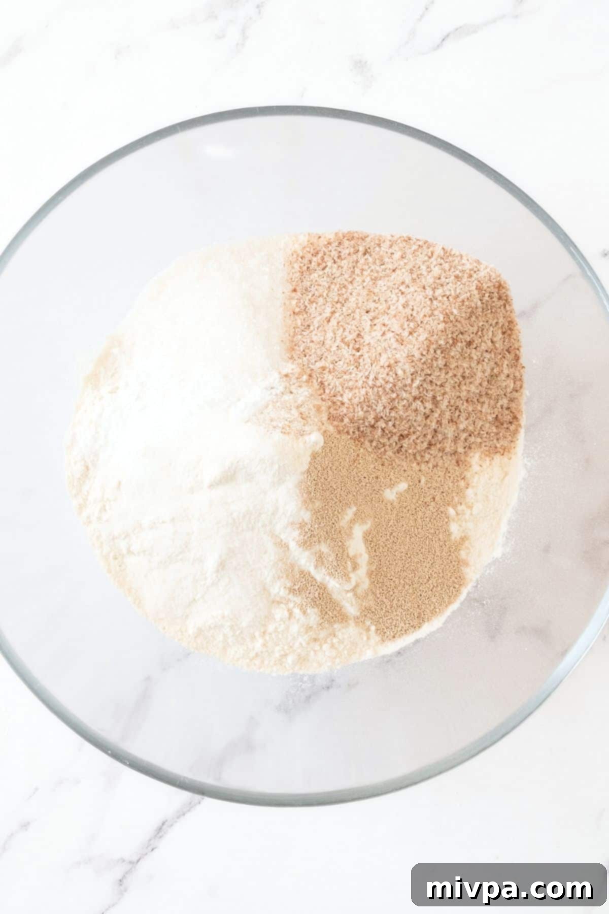 Easy Hot Dog Buns (Gluten-Free) Dry ingredients in glass mixing bowl.