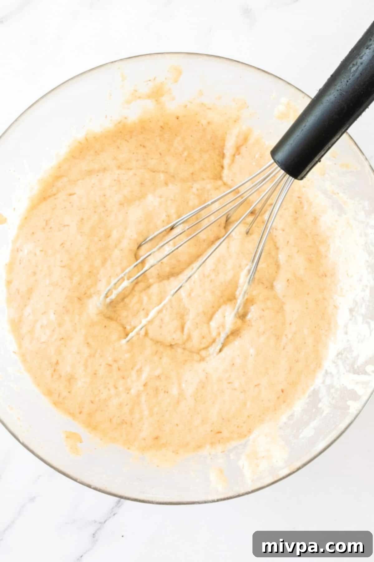 Gluten-Free Dairy-Free Hot Dog Buns Mixing gluten-free dough in glass mixing bowl.