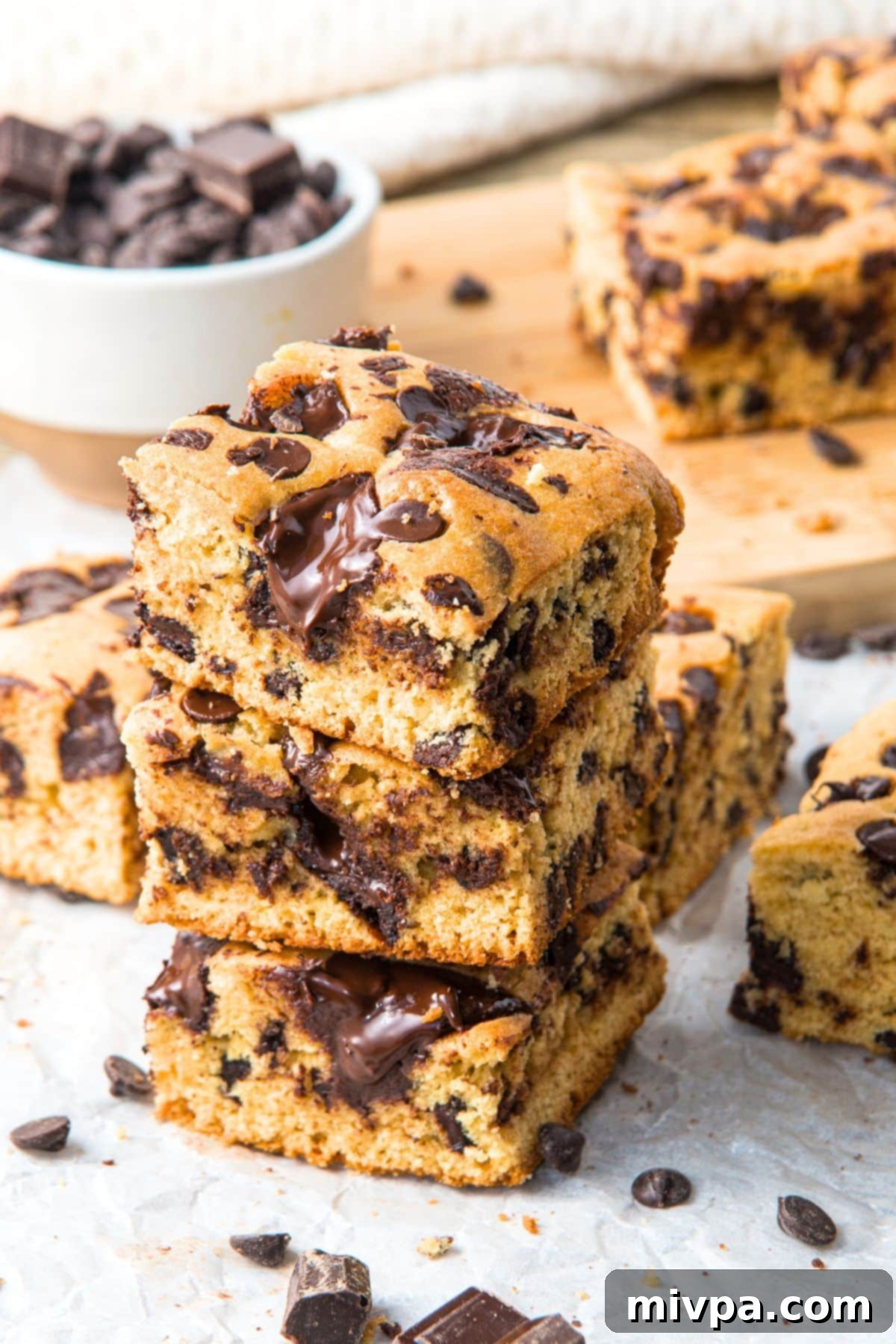 Gluten-Free Cookie Bars (Dairy-Free) Stacked Gluten-free dairy-free chocolate chip cookie bars stacked neatly, showing their soft interior and generous chocolate distribution.