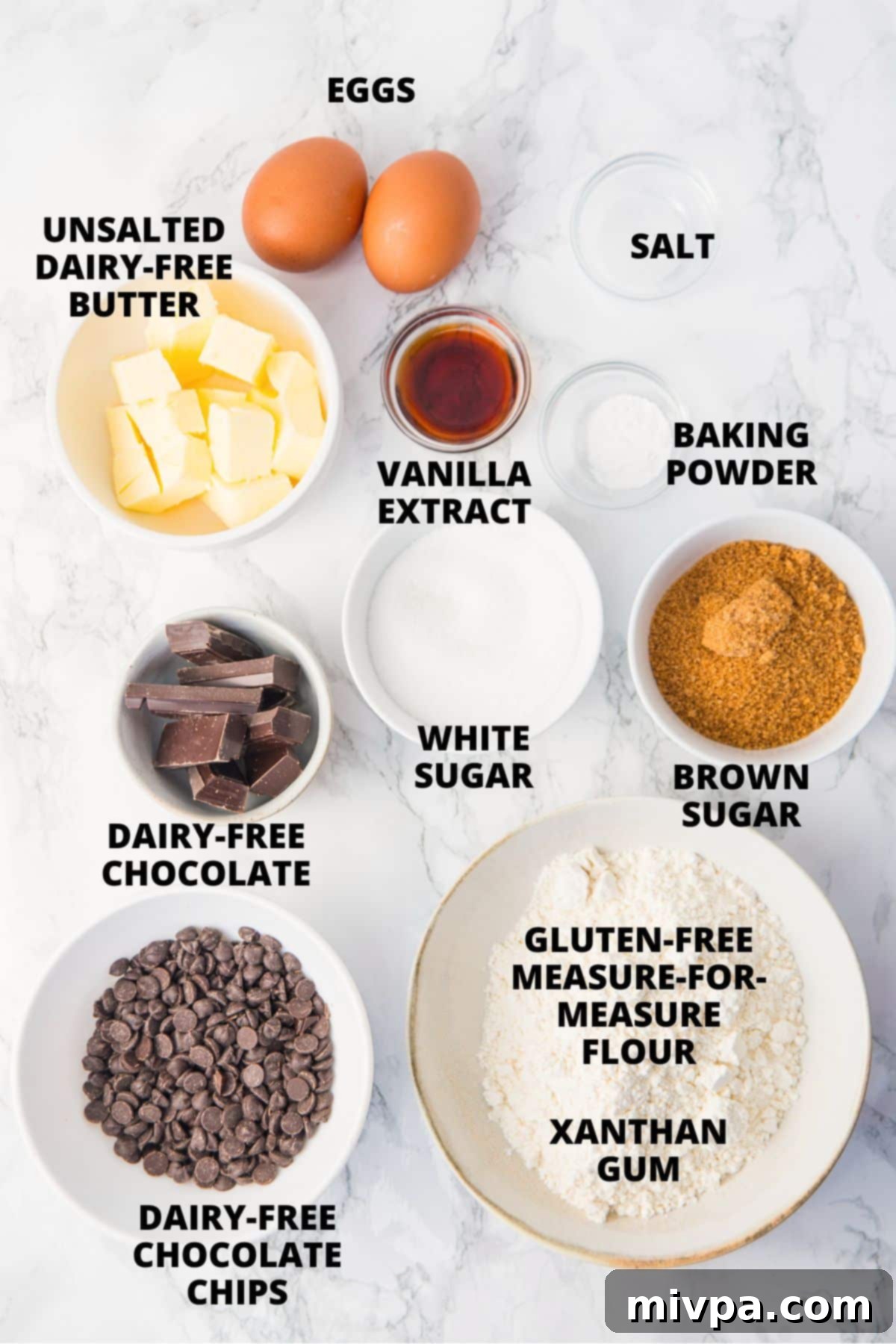 Gluten-Free Chocolate Chip Cookie Bar Recipe Ingredients All ingredients for gluten-free dairy-free chocolate chip cookie bars recipe laid out neatly on a marble board.