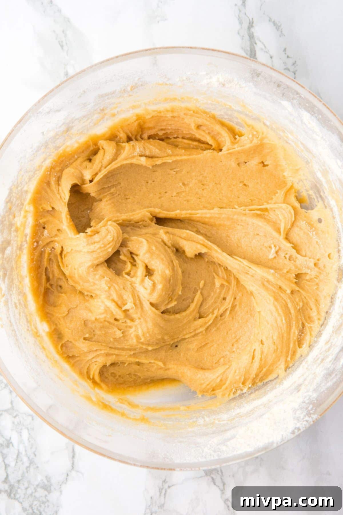 GF Cookie Dough Ready Rich cookie dough in a glass bowl, showing a smooth and well-combined texture.