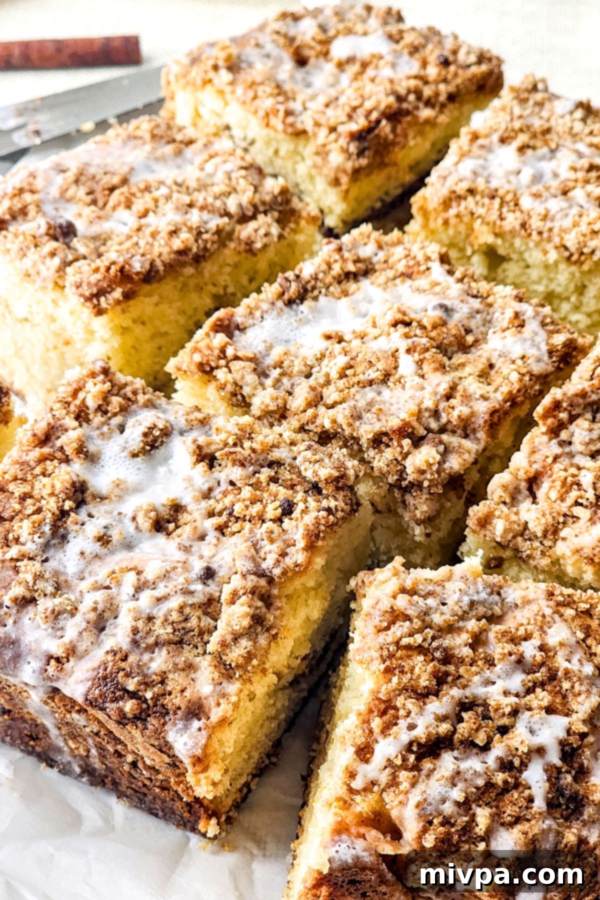 Cinnamon Crumble Cake (Gluten-Free) Ready to Serve An inviting close-up view of a slice of cinnamon crumble cake, showing the perfect layers of cake and streusel, ready to be enjoyed.