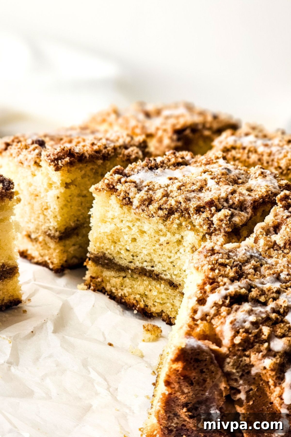 Gluten-Free Crumb Cake Texture A close-up view showcasing the tender, moist texture of the gluten-free crumb cake, complete with its streusel topping and light glaze.