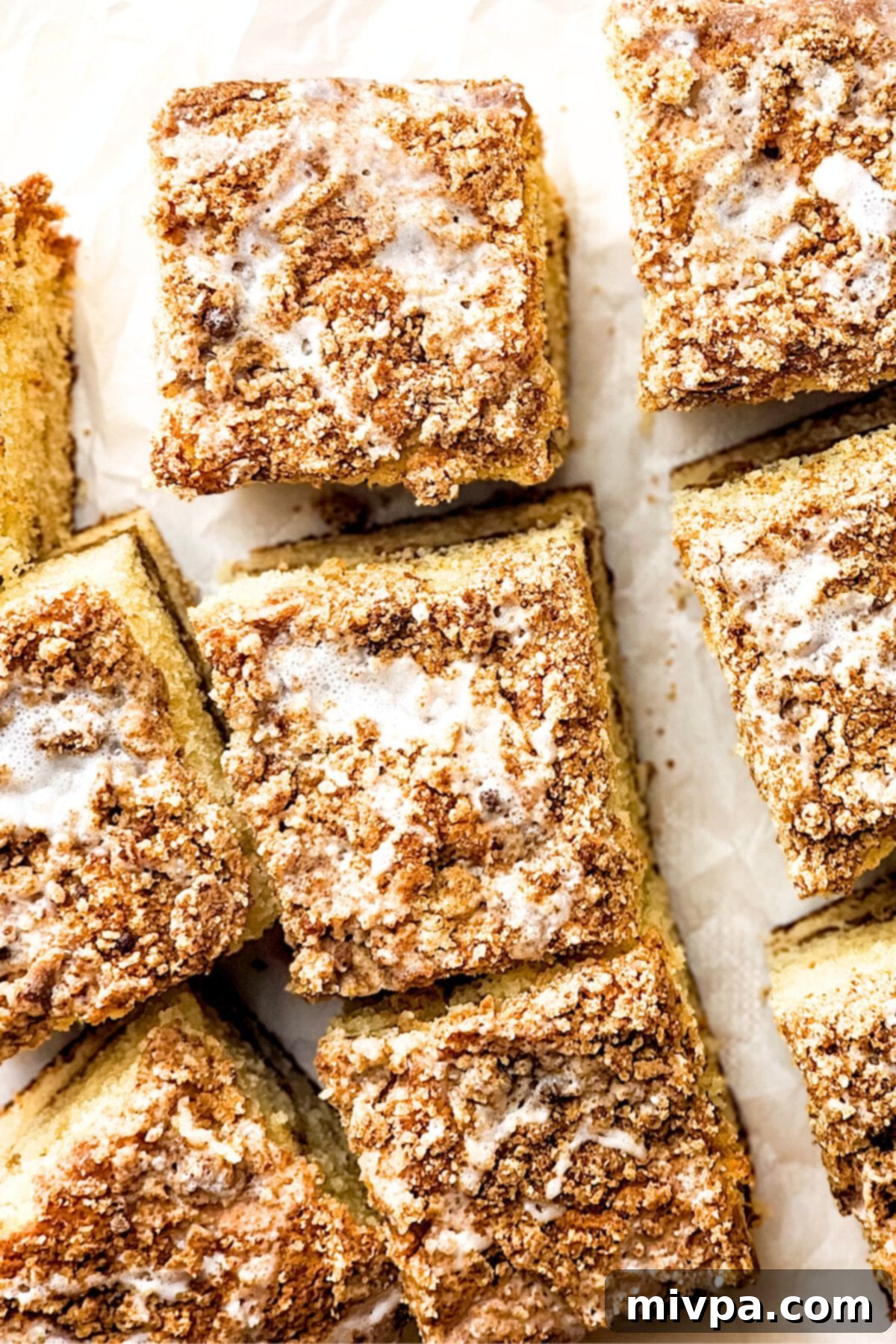 Easy Gluten-Free Crumble Cake Pieces Top-down view of several pieces of golden-brown gluten-free crumble cake, showcasing the rich streusel topping and moist interior.
