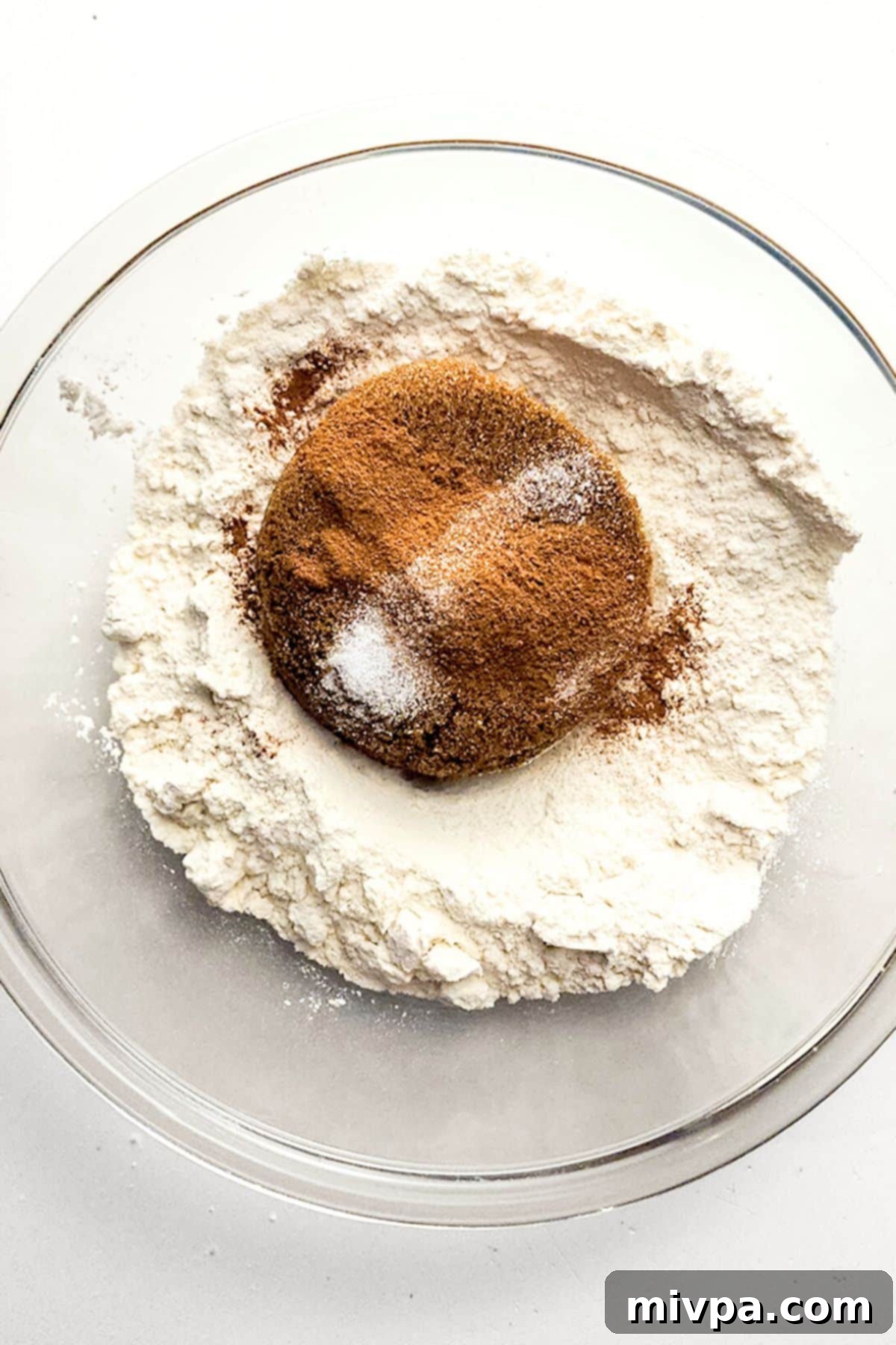 Easy Gluten-Free Cinnamon Crumb Cake Streusel Dry Ingredients A bowl containing a mixture of cinnamon, gluten-free flour, and brown sugar, prepared for the streusel topping.