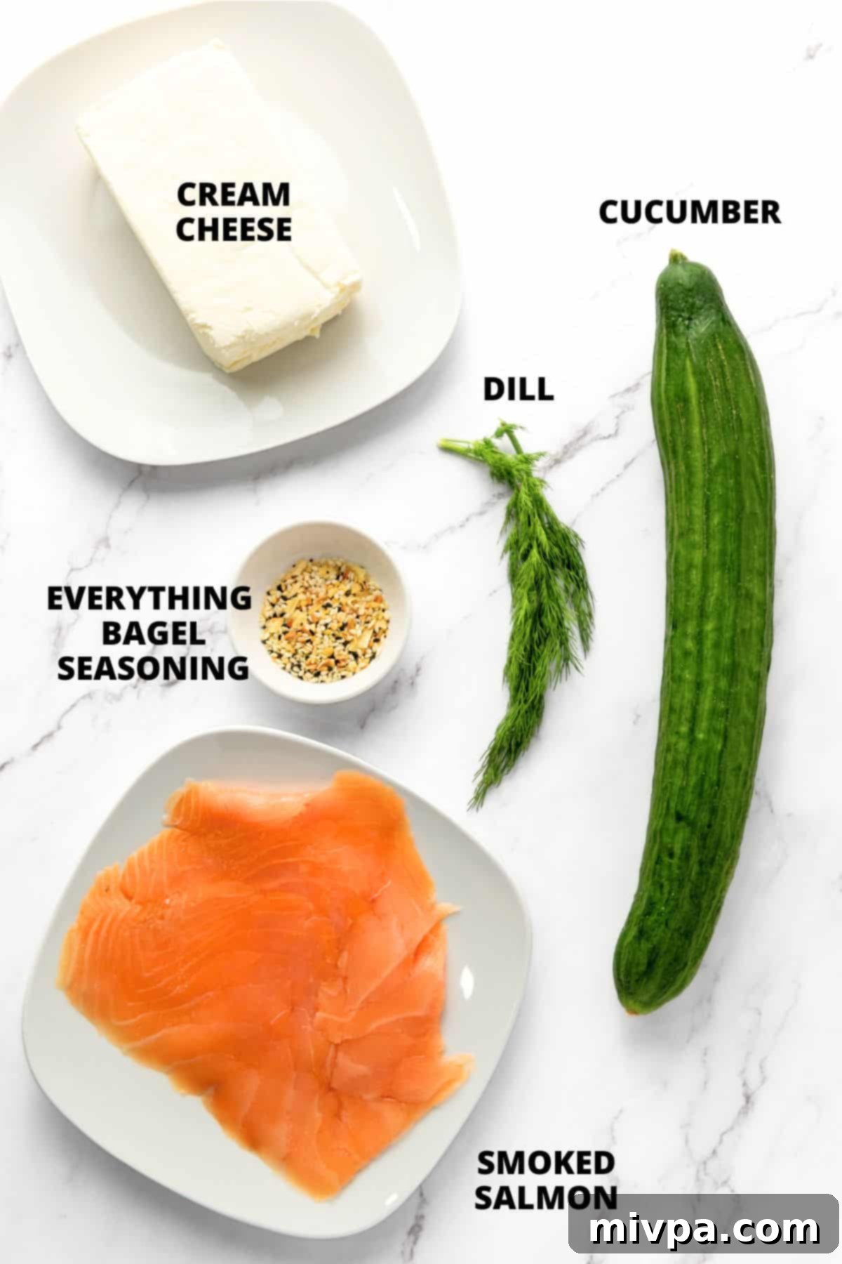 Gluten-Free Cucumber Roll Ups Ingredients required for salmon cucumber roll ups recipe on marble board.