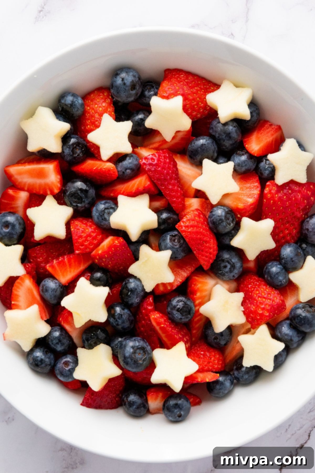 Patriotic Fruit Salad (Gluten-Free, Vegan) Top down view of a bowl of patriotic fruit salad.