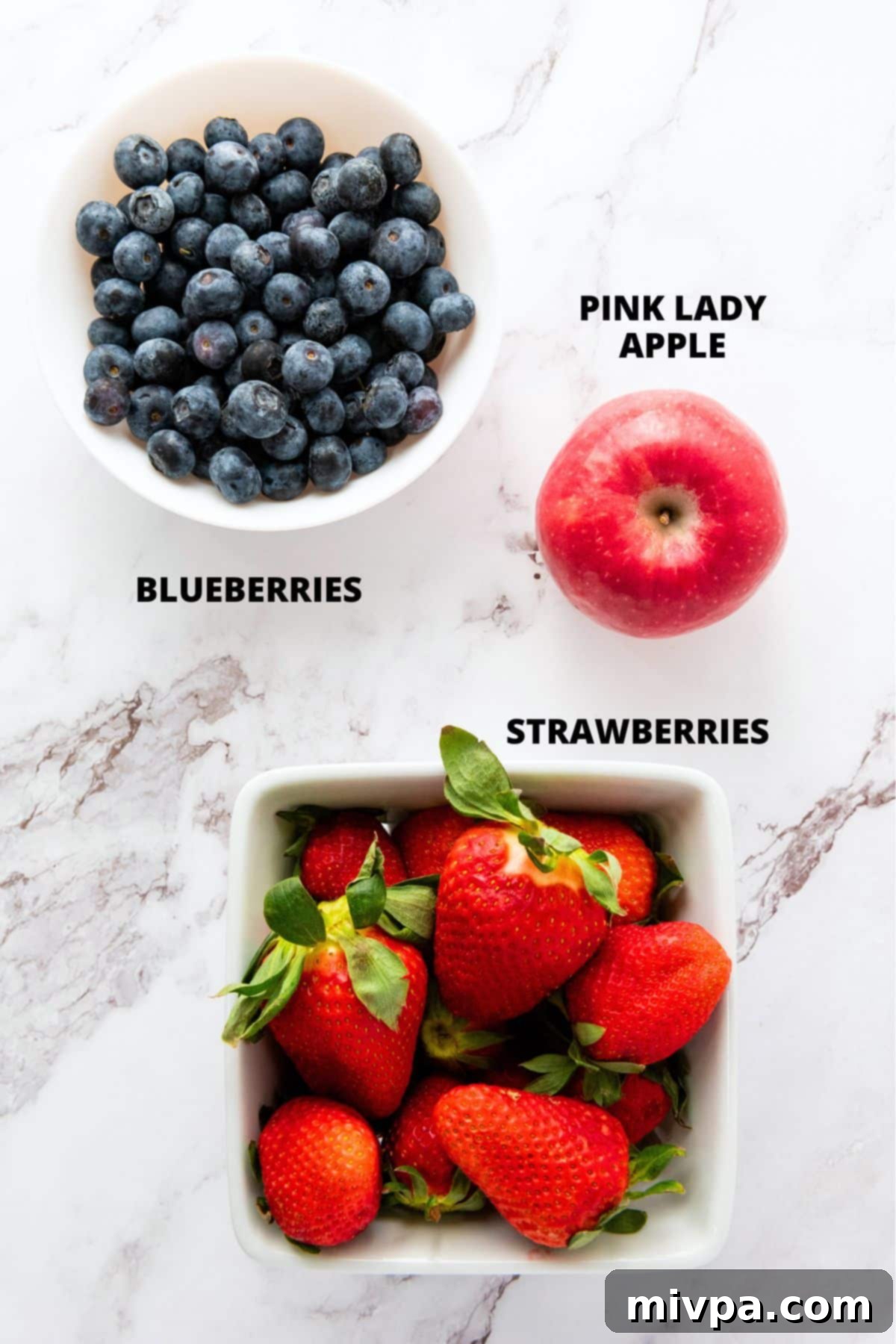 Patriotic Fruit Salad Recipe (Gluten-Free, Vegan) Ingredients for patriotic fruit salad recipe laid out on marble board.