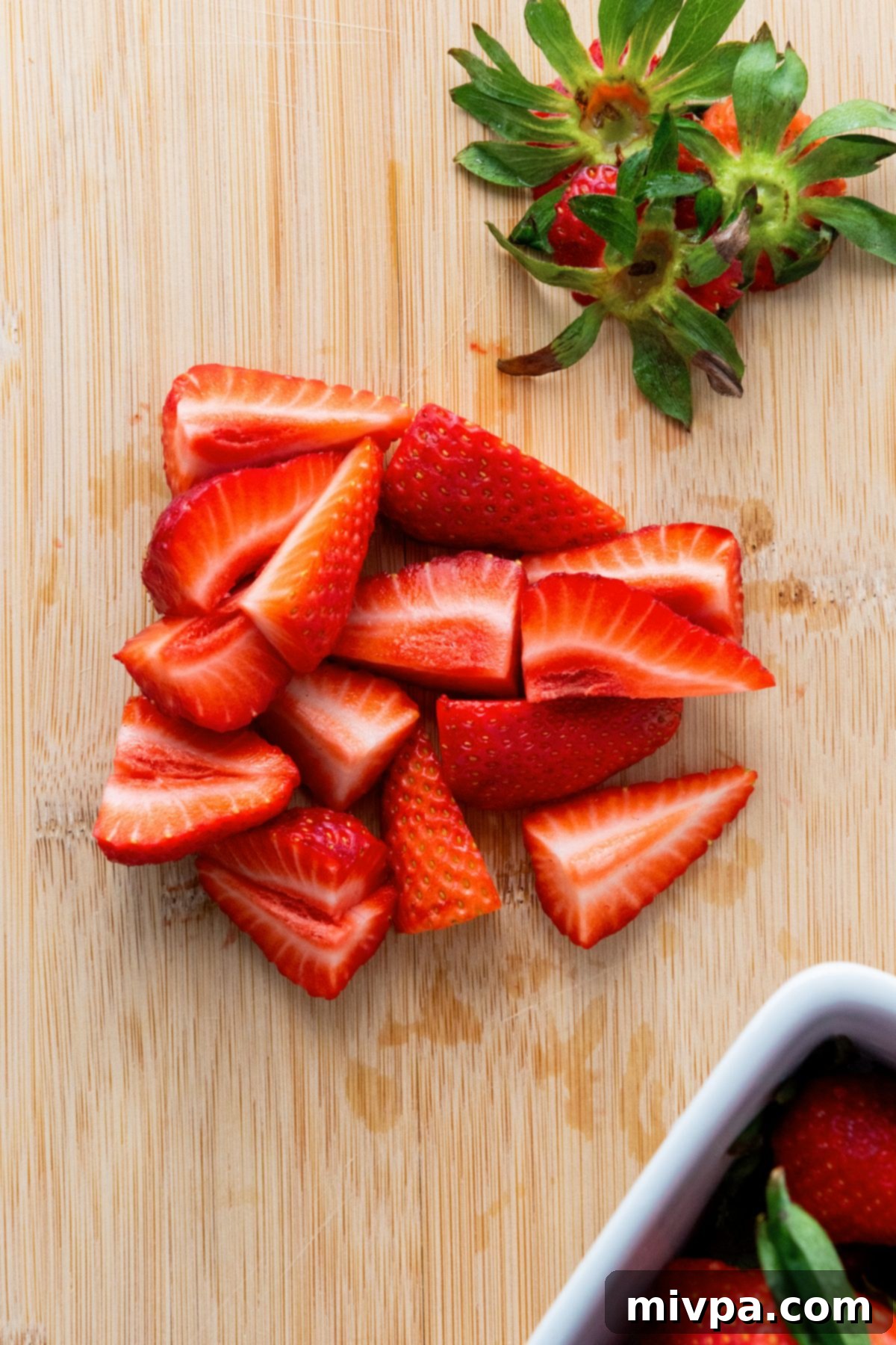 Red White and Blue Fruit Salad Sliced fresh strawberries on wooden board.