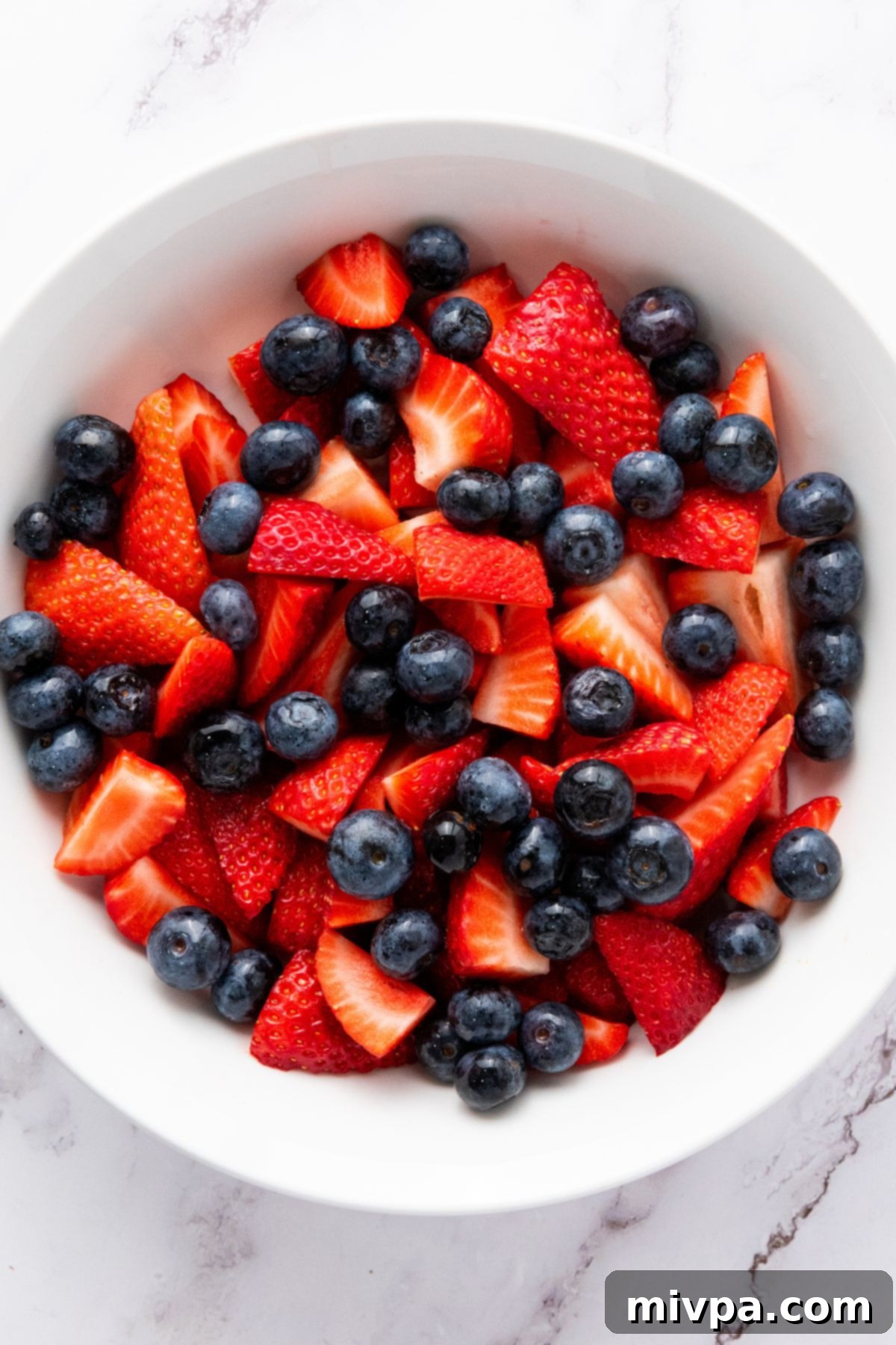 Patriotic Fruit Salad (Gluten-Free, Vegan) A bowl of fresh sliced strawberries and blueberries.