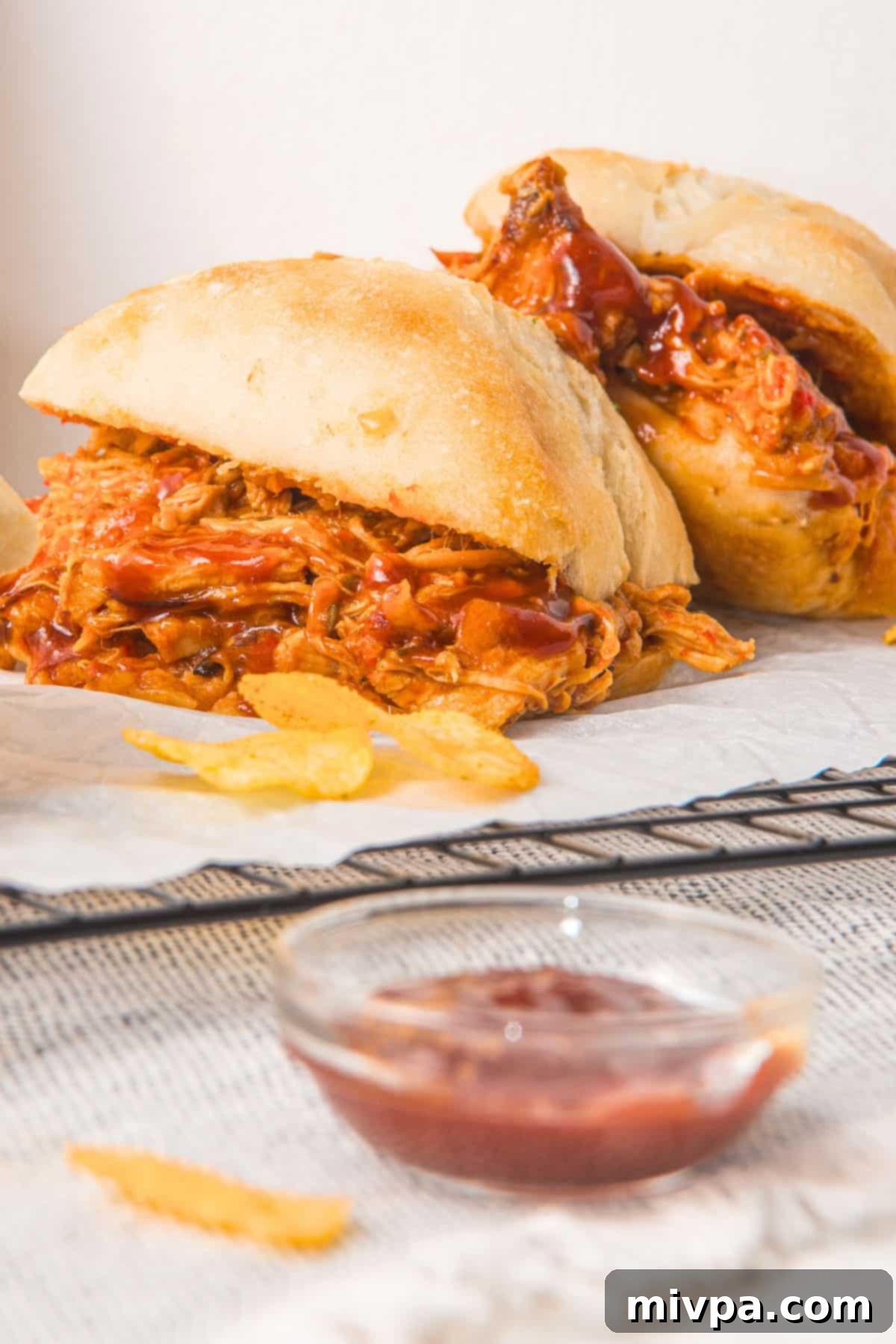 Gluten-Free Pulled Pork Sandwiches Two pulled pork sandwiches on wire rack