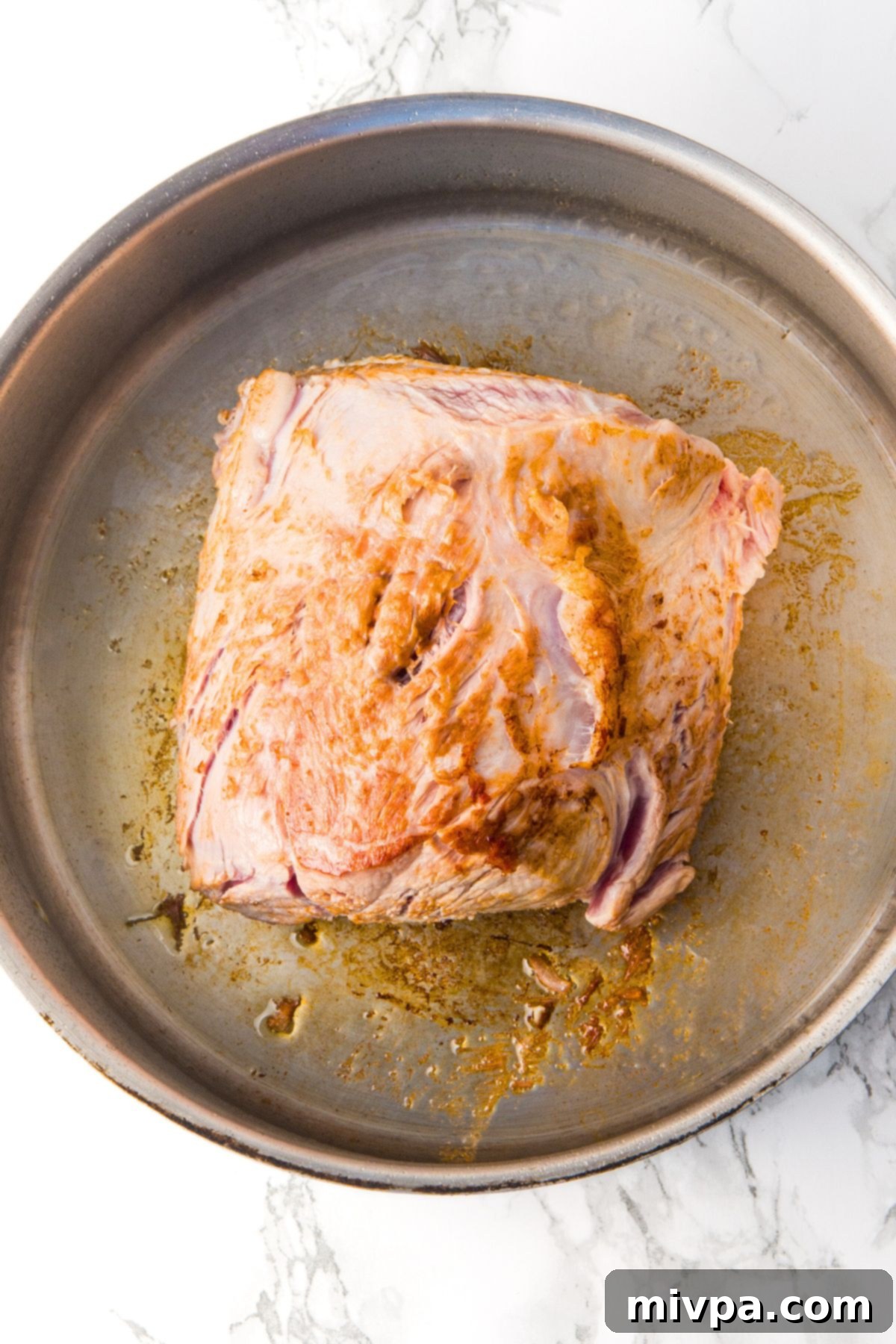 Searing pork shoulder in pot.