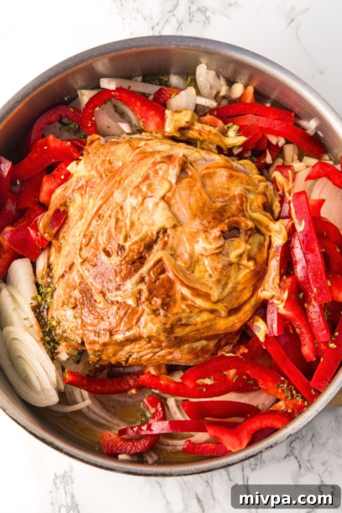 A pot with pork and sliced veggies.