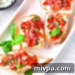 Simple Gluten Free Vegan Bruschetta 3 Tomato basil bruschetta on serving plate.