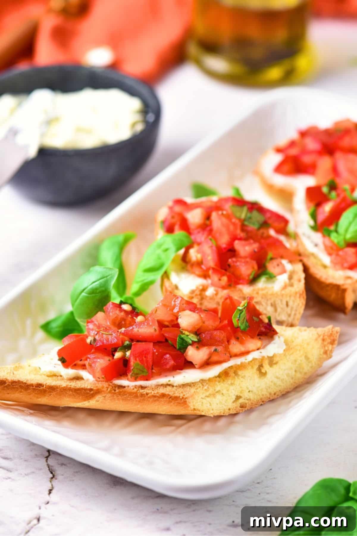Gluten-Free Vegan Bruschetta Up close view of gluten-free vegan bruschetta on serving platter.