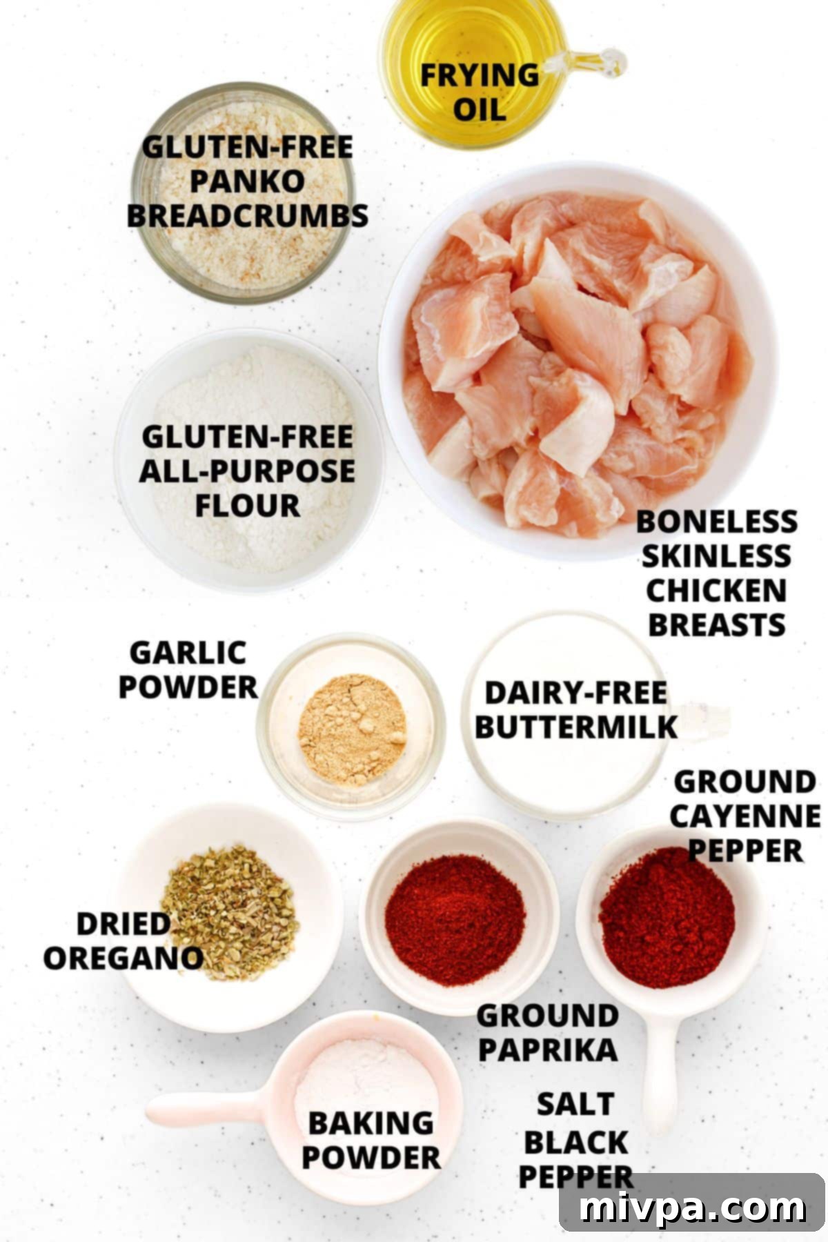 Ingredients for gluten-free popcorn chicken recipe laid out on white board.