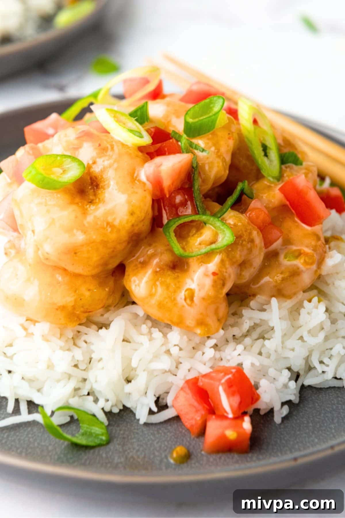 Gluten-Free Bang Bang Shrimp (Dairy-Free) Up close shot of gluten-free bang bang shrimp over rice.