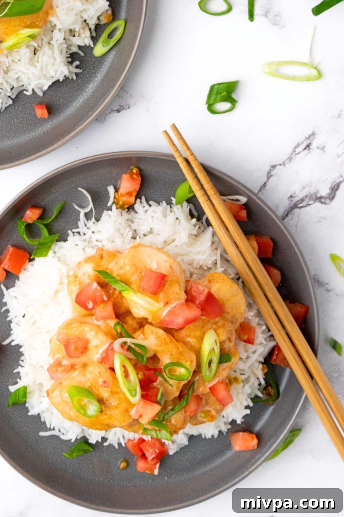 Healthy Bang Bang Shrimp Recipe Top down view of healthy bang bang shrimp over rice.