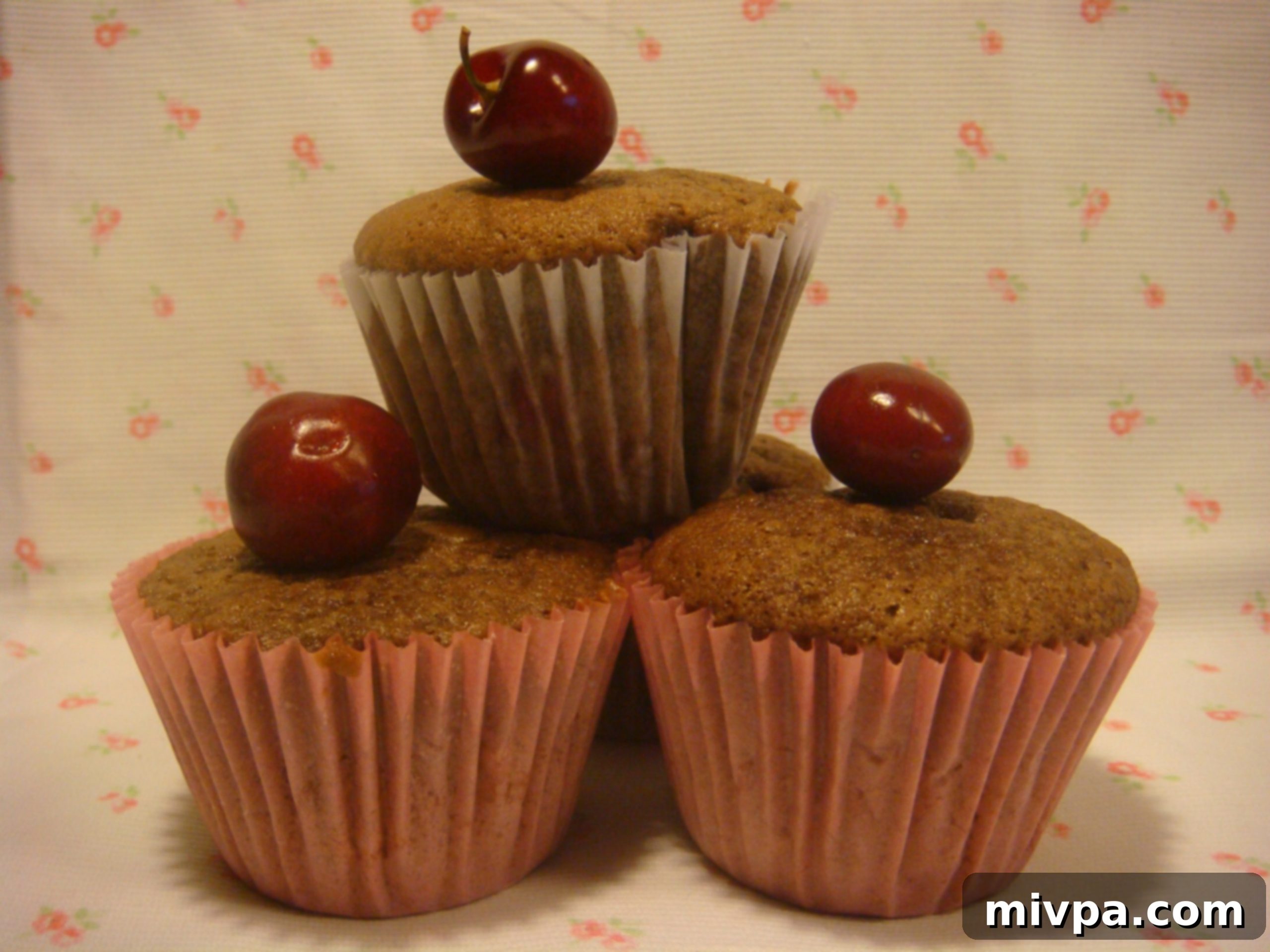 A close-up shot of a plate of delicious Cherry Chocolate Muffins, highlighting their texture and the tantalizing chocolate-cherry combination.