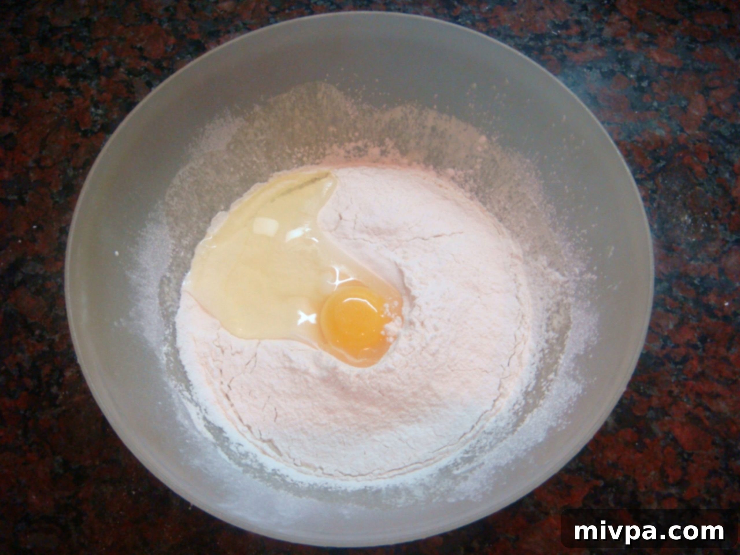 The process of adding self-raising flour and eggs alternately into the cream mixture, ensuring smooth incorporation.