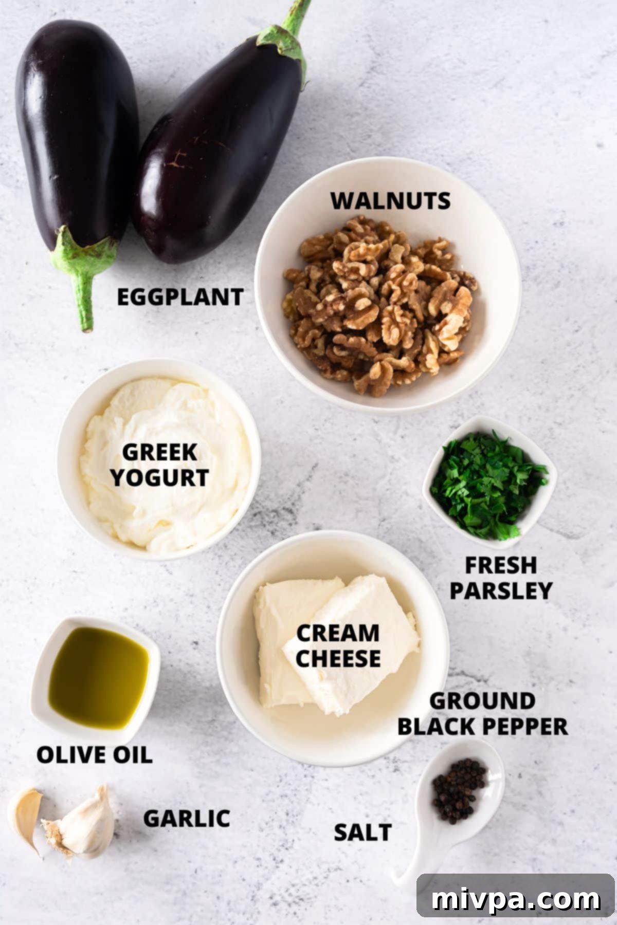 Top-down view of all the fresh ingredients for the eggplant roll ups recipe, neatly laid out on a wooden board, ready for preparation.