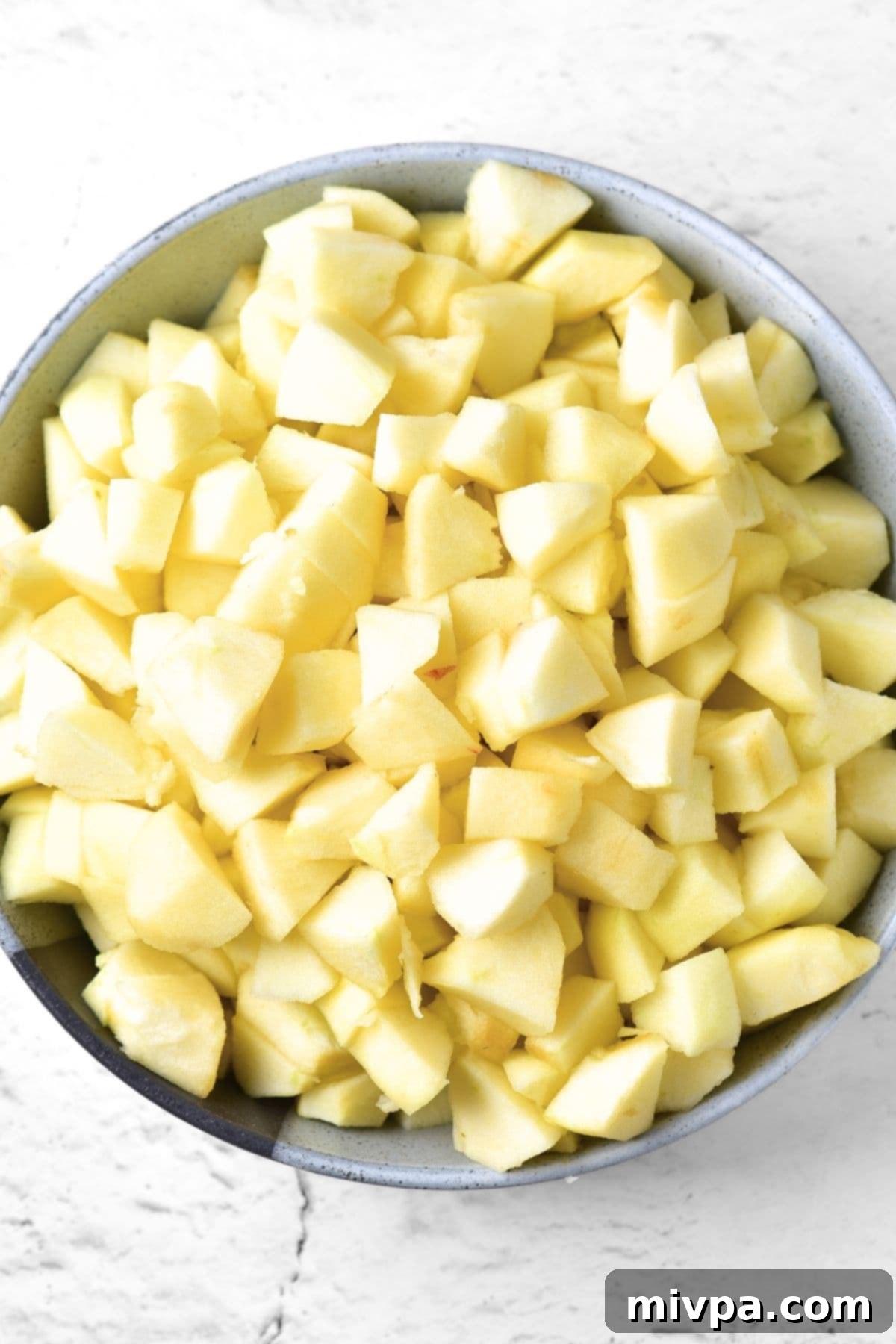 Cubed apples in a large bowl.
