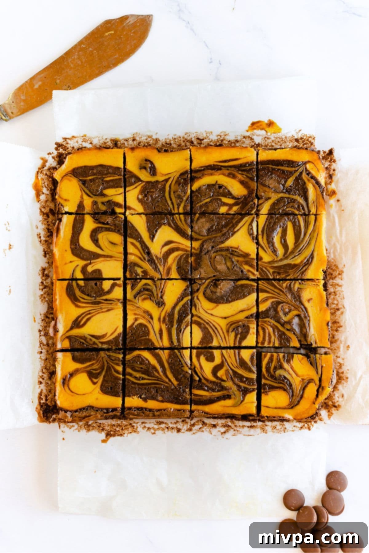 Pumpkin Swirl Cheesecake Brownies Sliced Top down view of perfectly sliced pumpkin swirl cheesecake brownies, displaying the distinct layers.