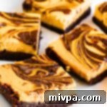 Irresistible Gluten Free Dairy Free Pumpkin Cheesecake Brownies 2 A delicious pumpkin cheesecake brownie served on a small white plate.