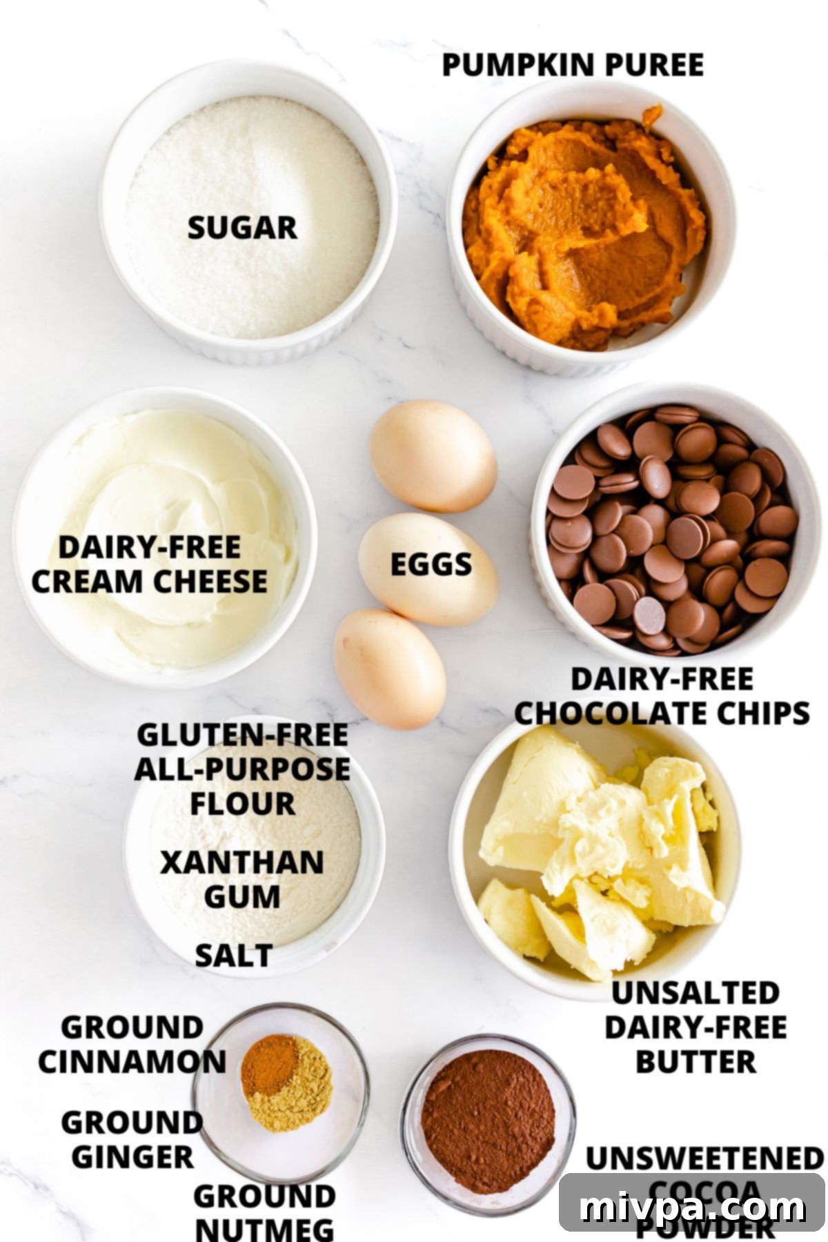 Pumpkin Cheesecake Brownies Recipe Ingredients All ingredients for the gluten-free dairy-free pumpkin cheesecake brownies recipe, neatly arranged on a marble board.
