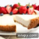 Reaching for a slice of creamy Greek yogurt cheesecake from a plate.