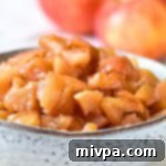 Simple Plant Based Gluten Free Caramel Apples 3 A bowl of caramelized apples with apples in the background