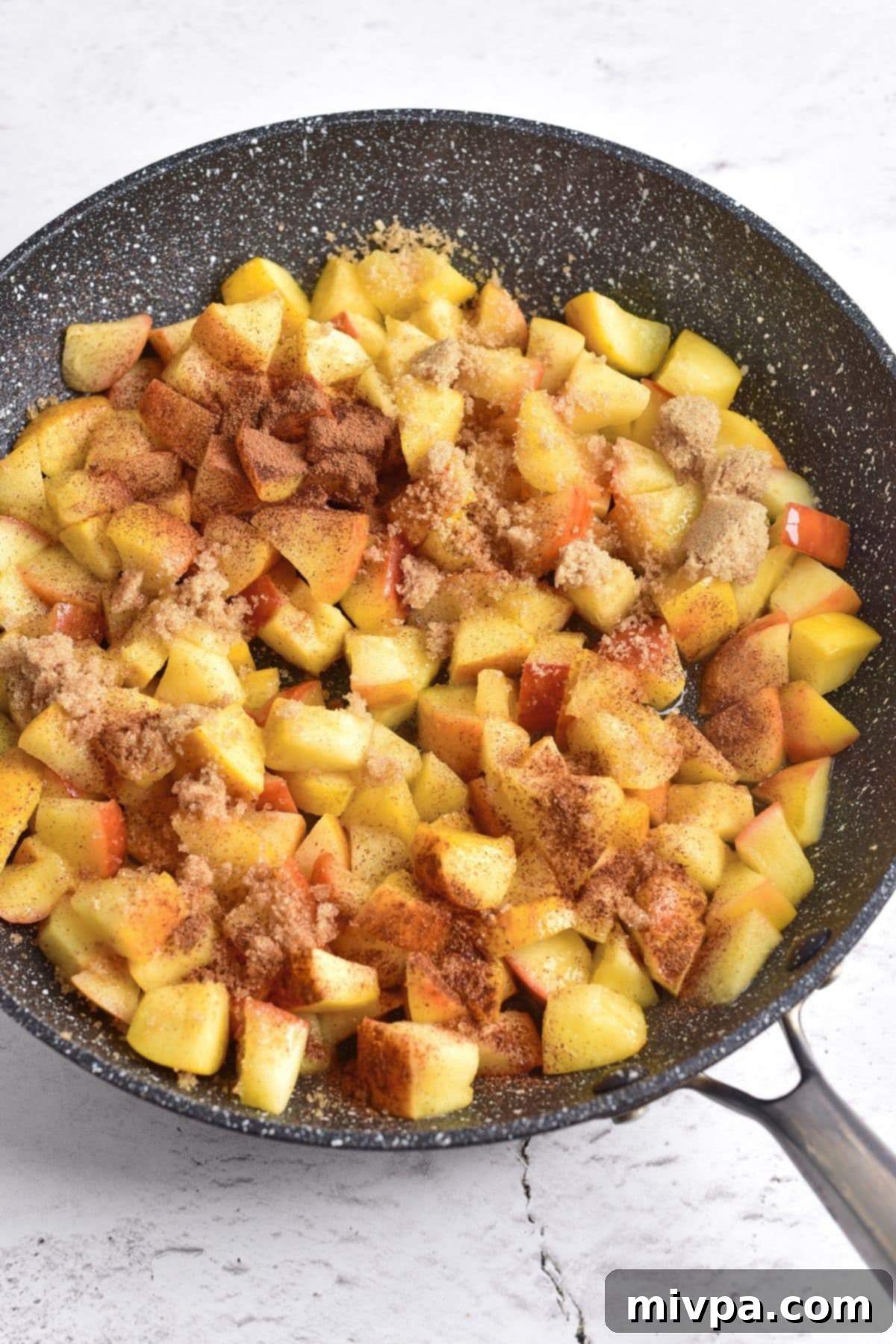 Homemade Caramelized Cinnamon Apples Spices sprinkled over cubed apples