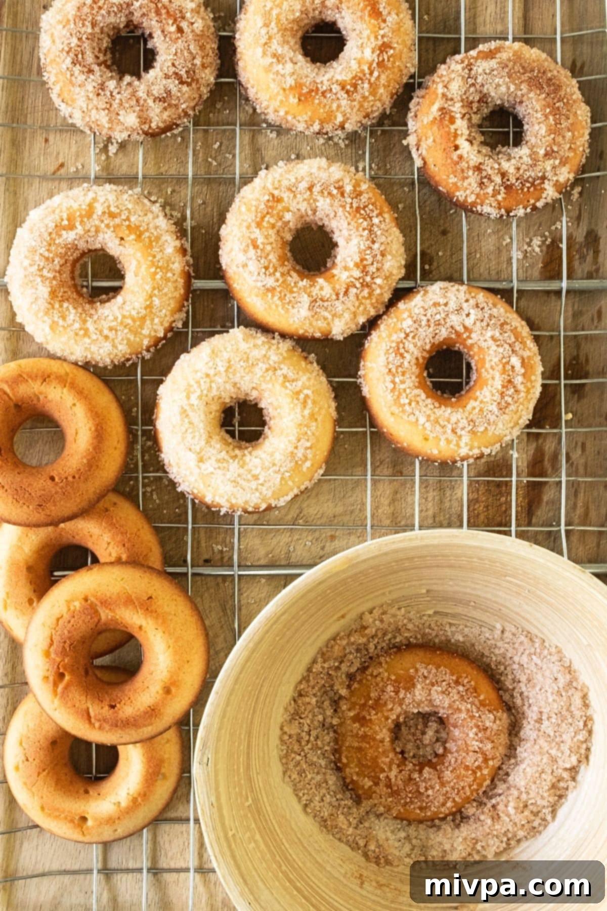 Coating donuts in cinnamon-sugar mixture